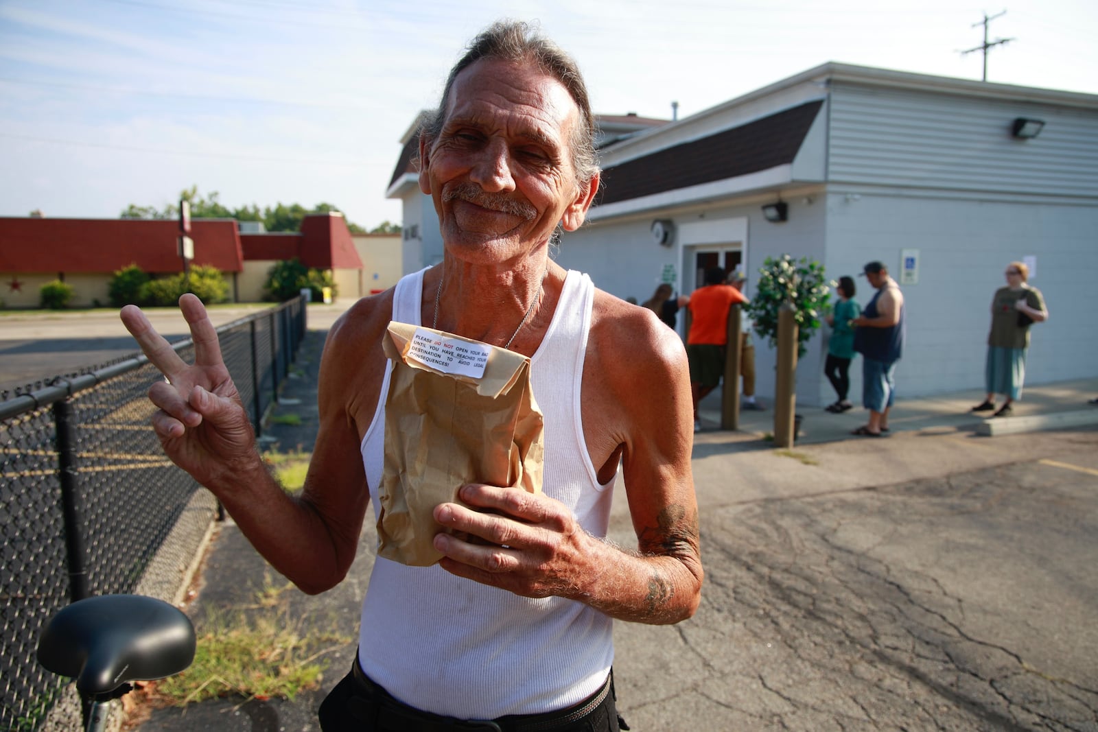 David Blystone, from Springfield, holds up his bag of pot after being the first person in line at The Forest in Springfield Tuesday, Aug. 6, 2024. BILL LACKEY/STAFF