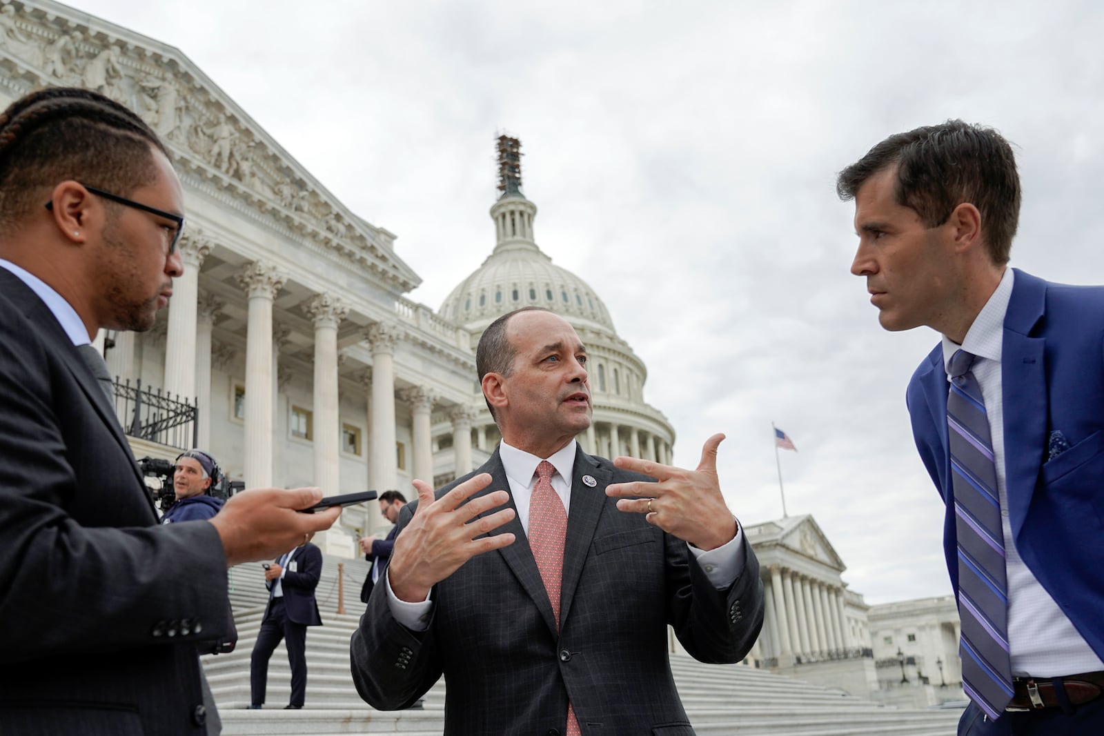 Rep. Greg Landsman, D-Ohio, center, talks with reporters on Capitol Hill, Friday, Oct. 20, 2023, in Washington. (AP Photo/Mariam Zuhaib)