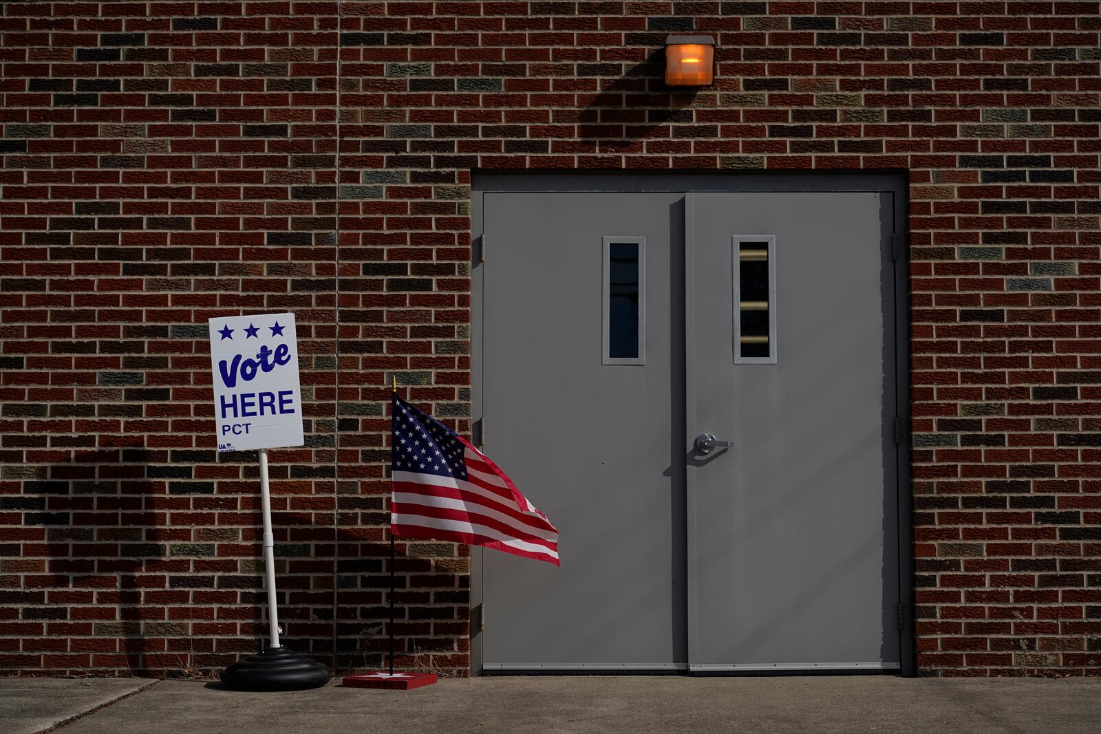 The door of the Jeffersonville Masonic Lodge polling location is marked with an American Flag and a "Vote Here" sign on Election Day in Jeffersonville, Ohio, Tuesday, Nov. 7, 2023. Polls are open in a few states for off-year elections that could give hints of voter sentiment ahead of next year's critical presidential contest. (AP Photo/Carolyn Kaster)