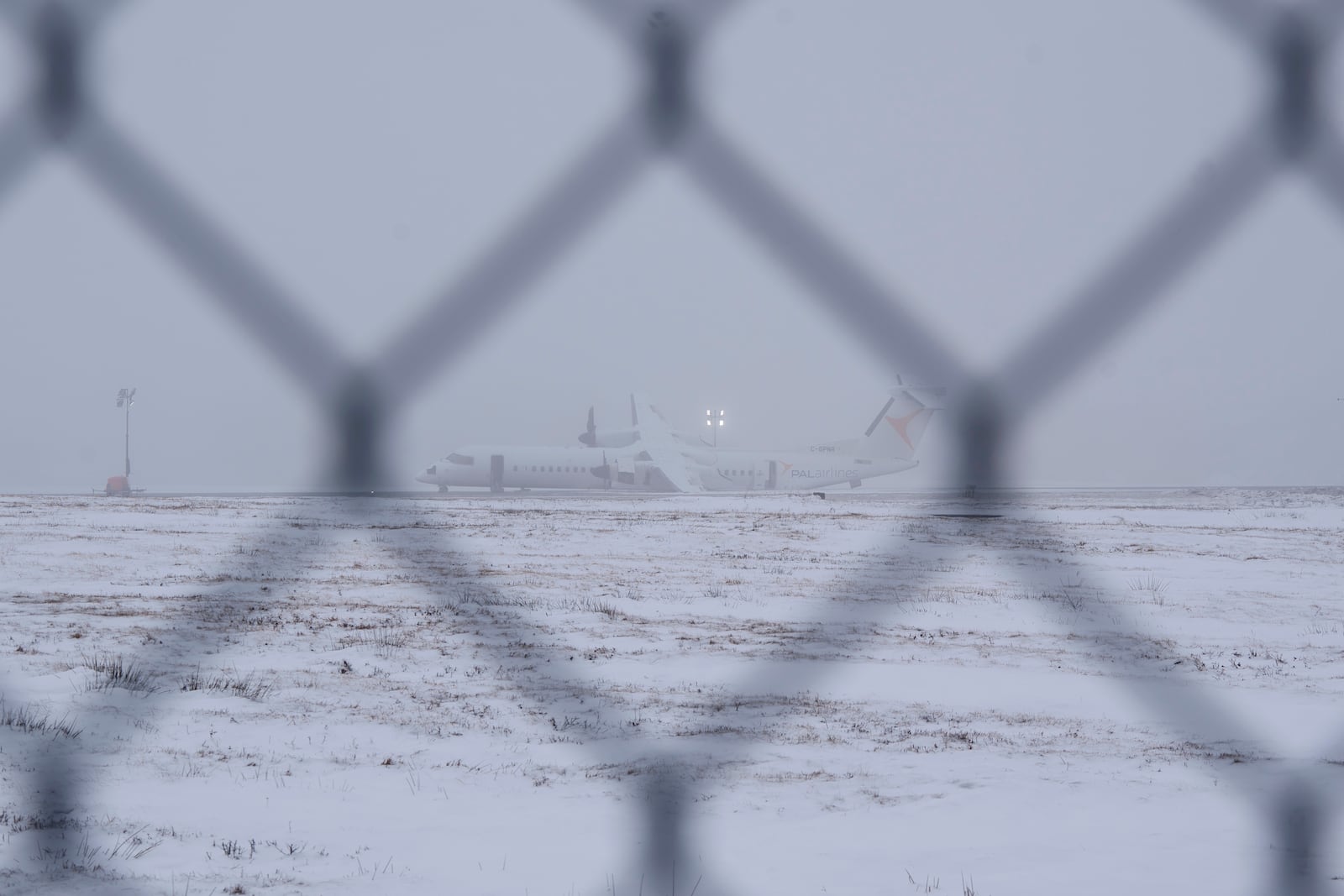 An aircraft that skidded off the runway Saturday night after catching fire at Halifax Stanfield International Airport is seen on Sunday, Dec. 29, 2024, in Halifax, Nova Scotia. (Darren Calabrese/The Canadian Press via AP)