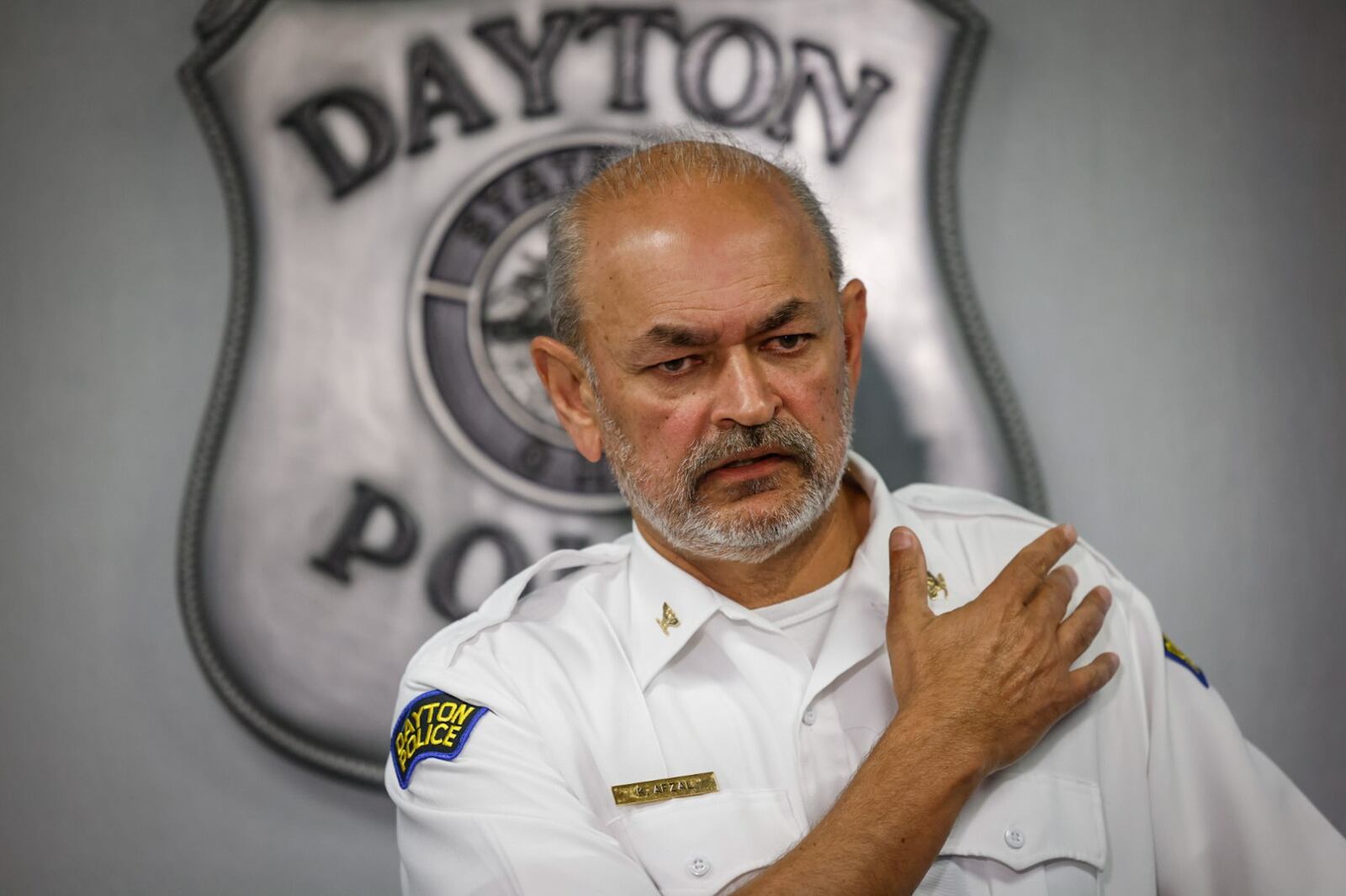 Dayton police chief Kamran Afzal points to the place where the teenager was shot by officers on Saturday. JIM NOELKER/STAFF