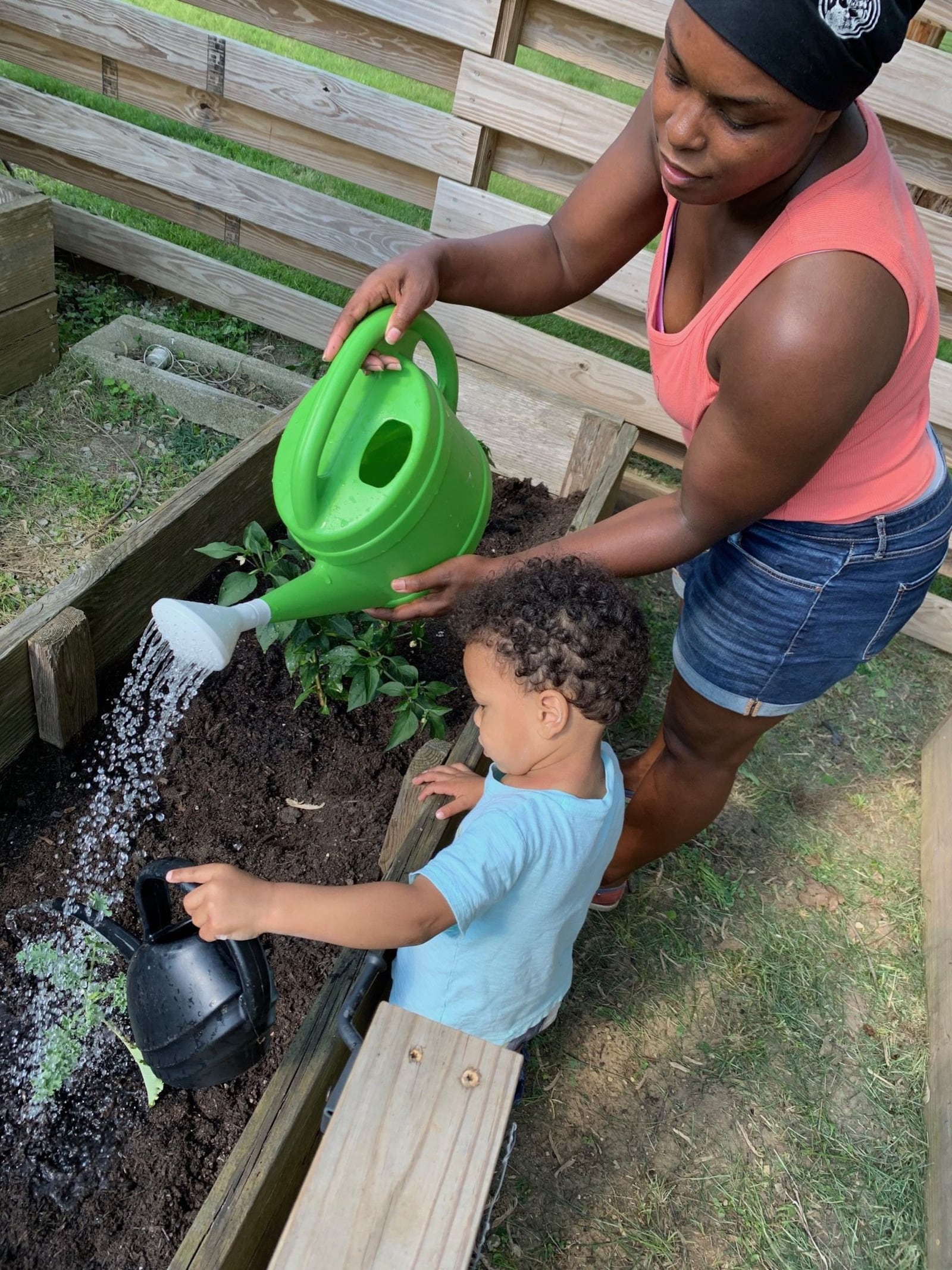 Artist and curatorial assistant Cydnie King works in the garden with her son. “I go out to the garden at the end of the day and Isaac helps me water the flowers and weed." 