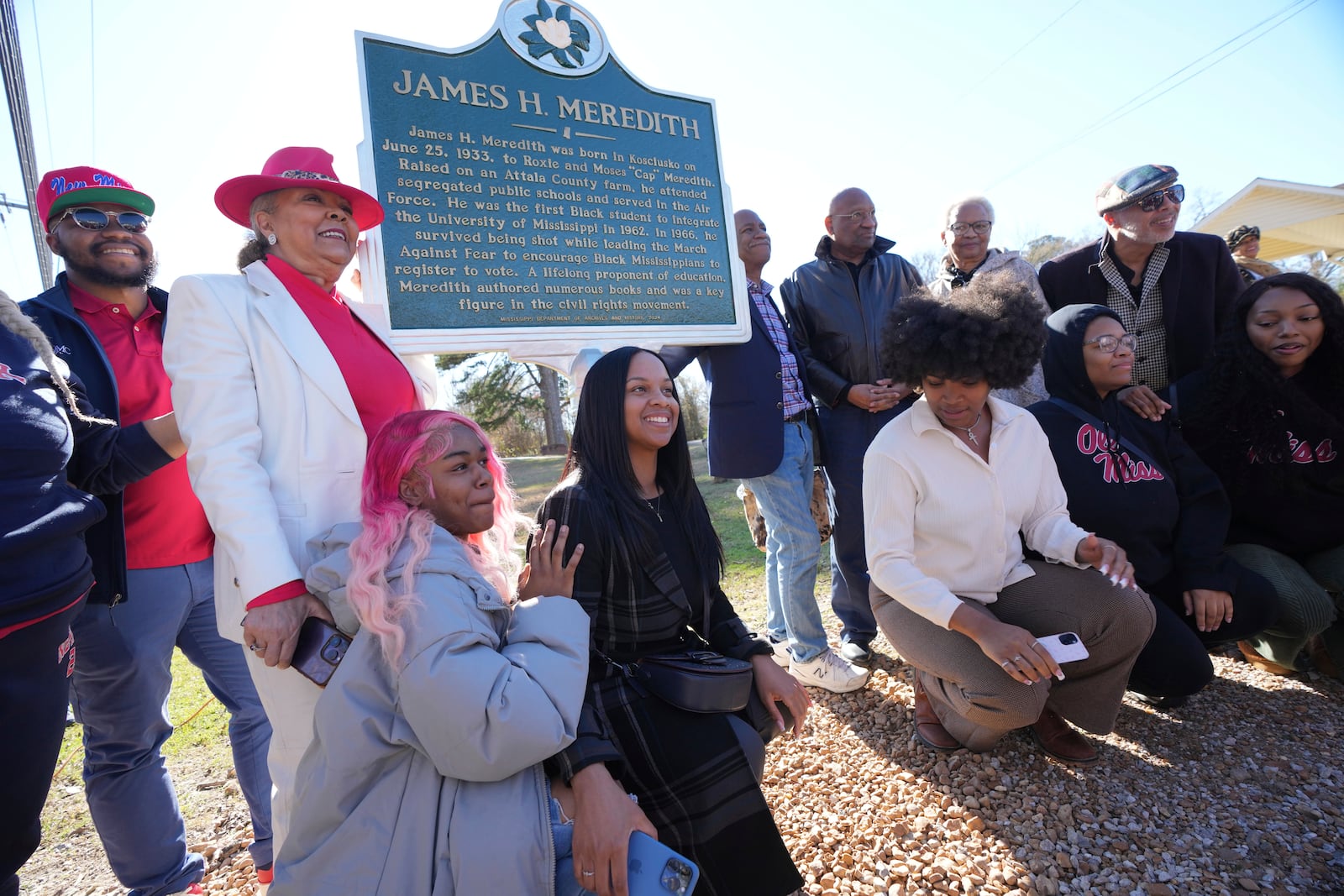 Family members celebrate the legacy of James Meredith who became the first Black student to enroll at the University of Mississippi in 1962, following the unveiling of a Mississippi Department of Archives and History marker recognizing his birthplace in Kosciusko, Miss., Friday, Dec. 20, 2024. (AP Photo/Rogelio V. Solis)