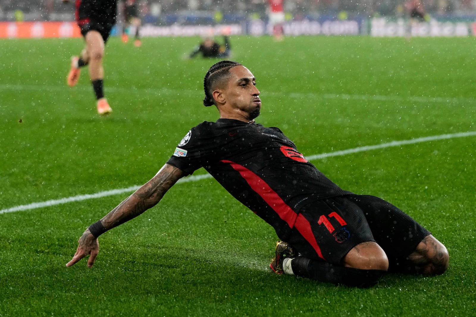 Barcelona's Raphinha celebrates his side's fifth goal during a Champions League opening phase soccer match between SL Benfica and FC Barcelona at the Luz stadium in Lisbon, Tuesday, Jan. 21, 2025. (AP Photo/Armando Franca)