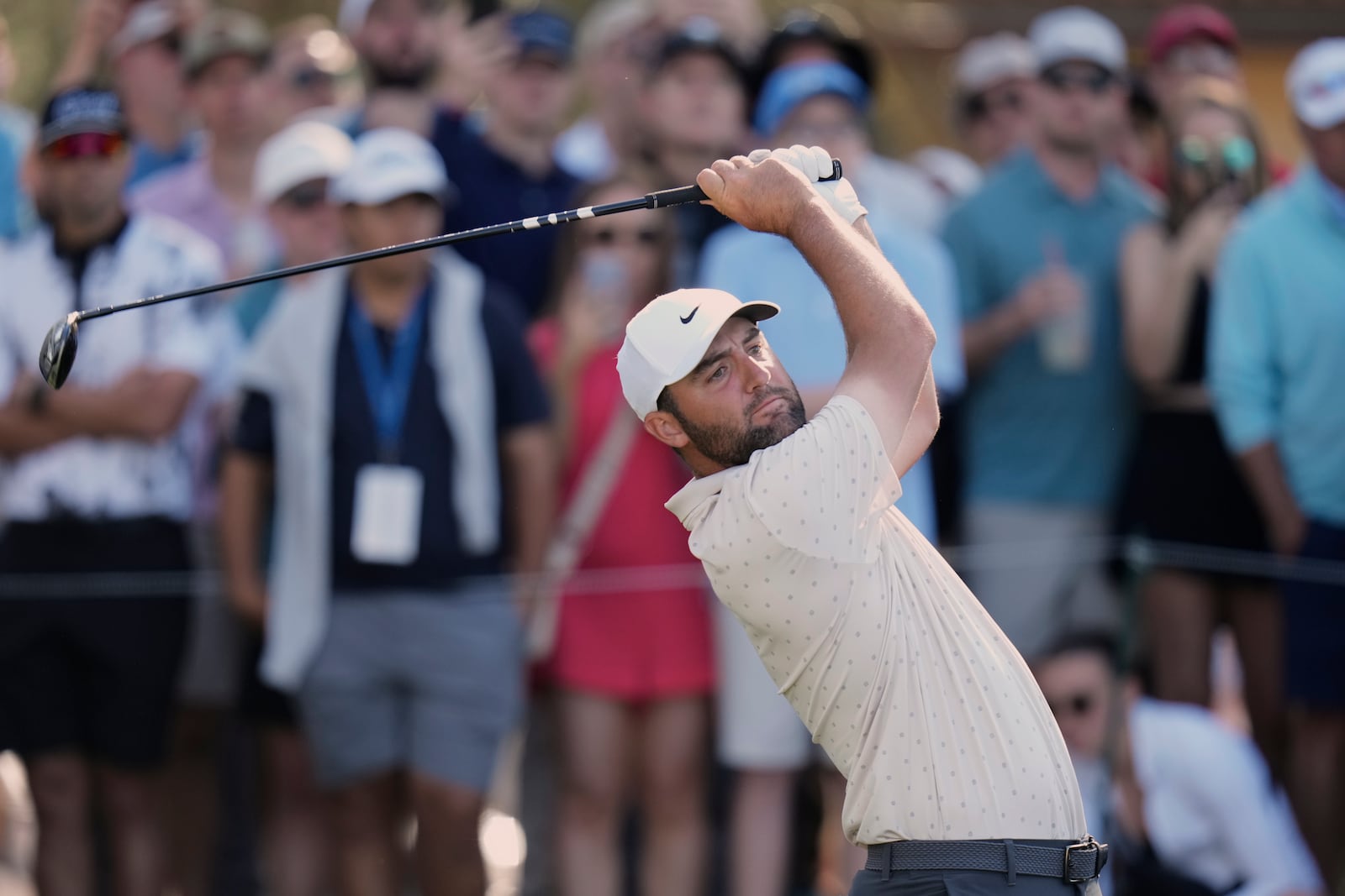 Scottie Scheffler hits his tee shot on the 12th hole during the first round of The Players Championship golf tournament Thursday, March 13, 2025, in Ponte Vedra Beach, Fla. (AP Photo/Chris O'Meara)