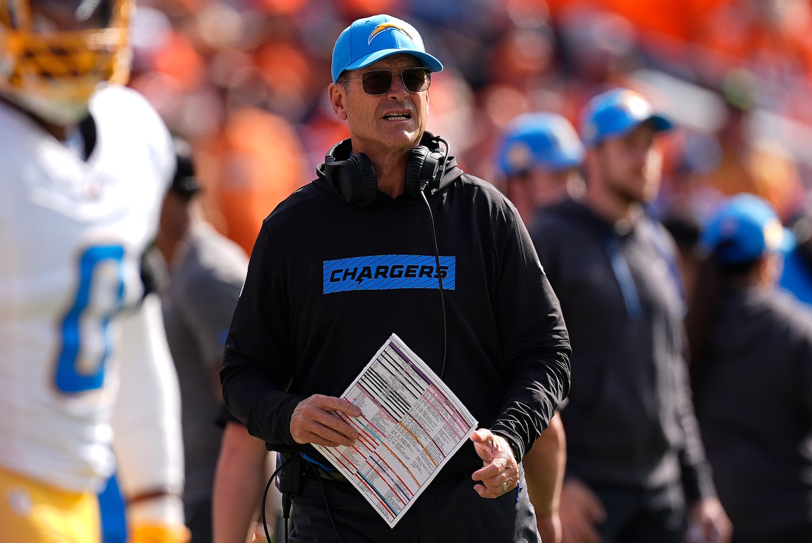 Los Angeles Chargers head coach Jim Harbaugh stands on the sideline during the first half of an NFL football game against the Denver Broncos, Sunday, Oct. 13, 2024, in Denver. (AP Photo/David Zalubowski)