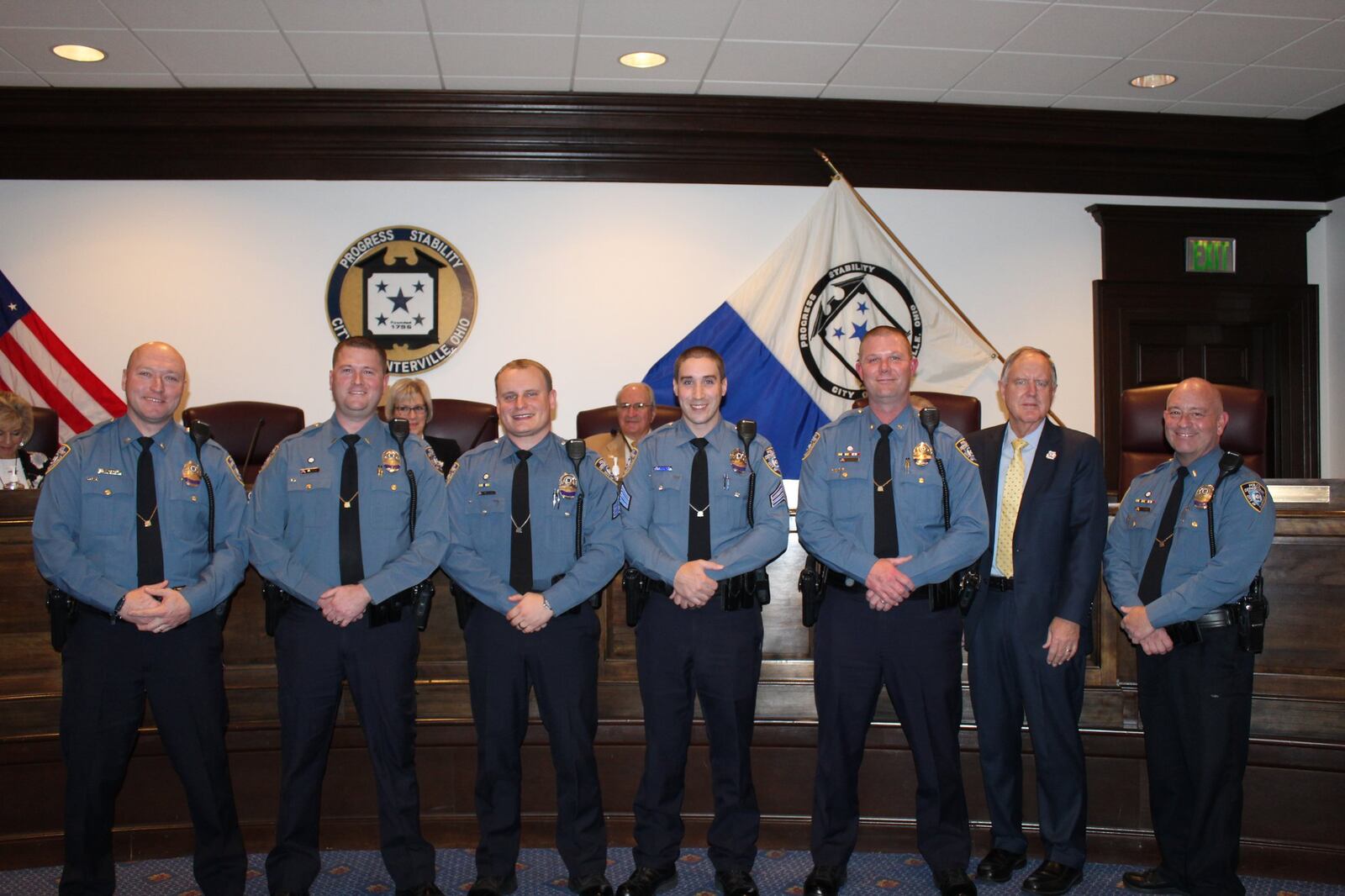 From L-R: Sgt. Michael Yoder, Sgt. Tyler Wilson, officer Anthony Green, officer Joshua Ratliff, chief Matt Brown, Mayor Brooks Compton and Lt. Joseph Lavigne are shown at the announcement of the promotions for the four officers.