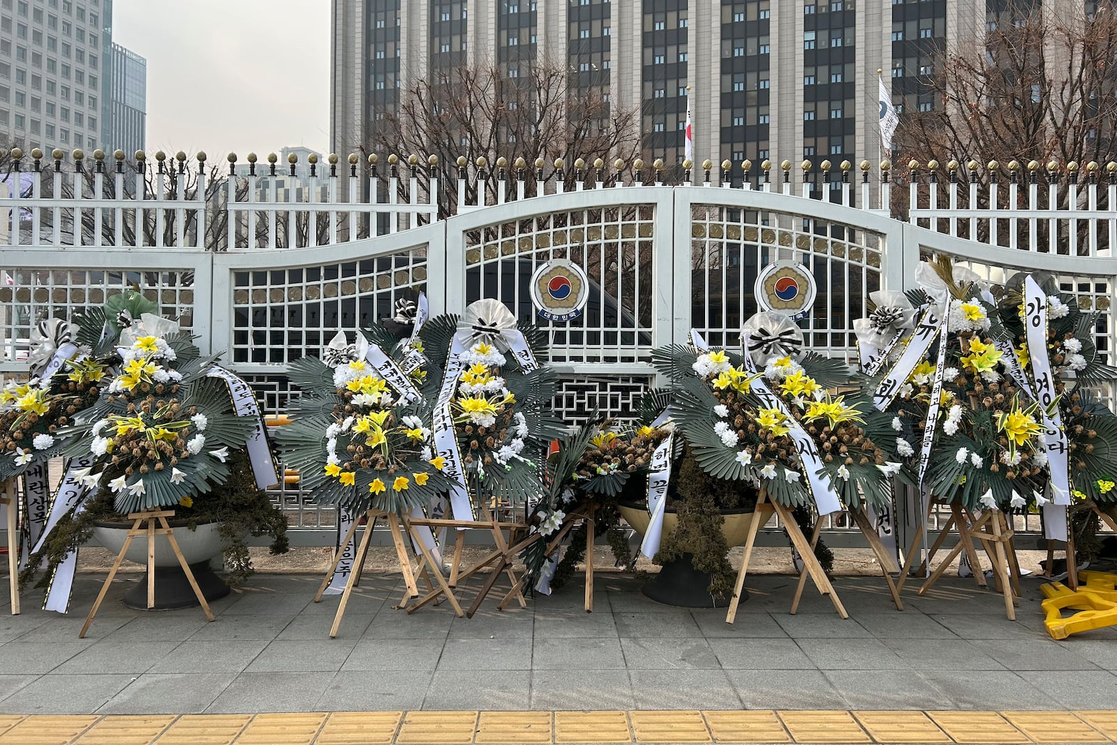 HOLD- Funeral wreaths bearing messages critical of officials involved in South Korea's martial law controversy stand outside the Government Complex Seoul on Monday, Jan. 20, 2025, in Seoul. (AP Photo/Juwon Park)