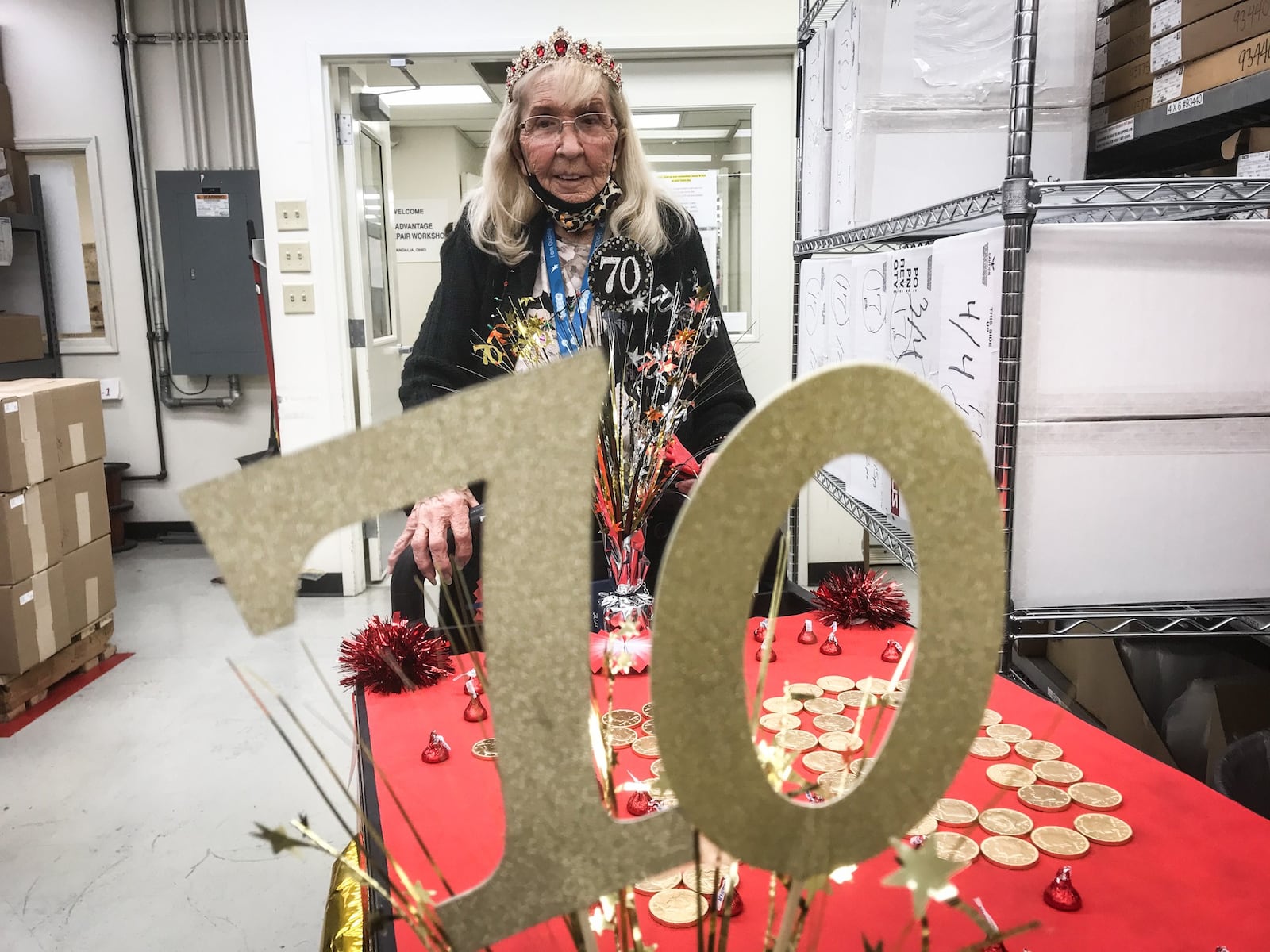 Surrounded by her coworkers, Doris Harakay, 89, parades through GE plant in Vandalia Friday morning Feb.19, 2021. Harakay has worked at the plant for 70 years and the company throw a party for her and her family. She doesn't plan to retire.