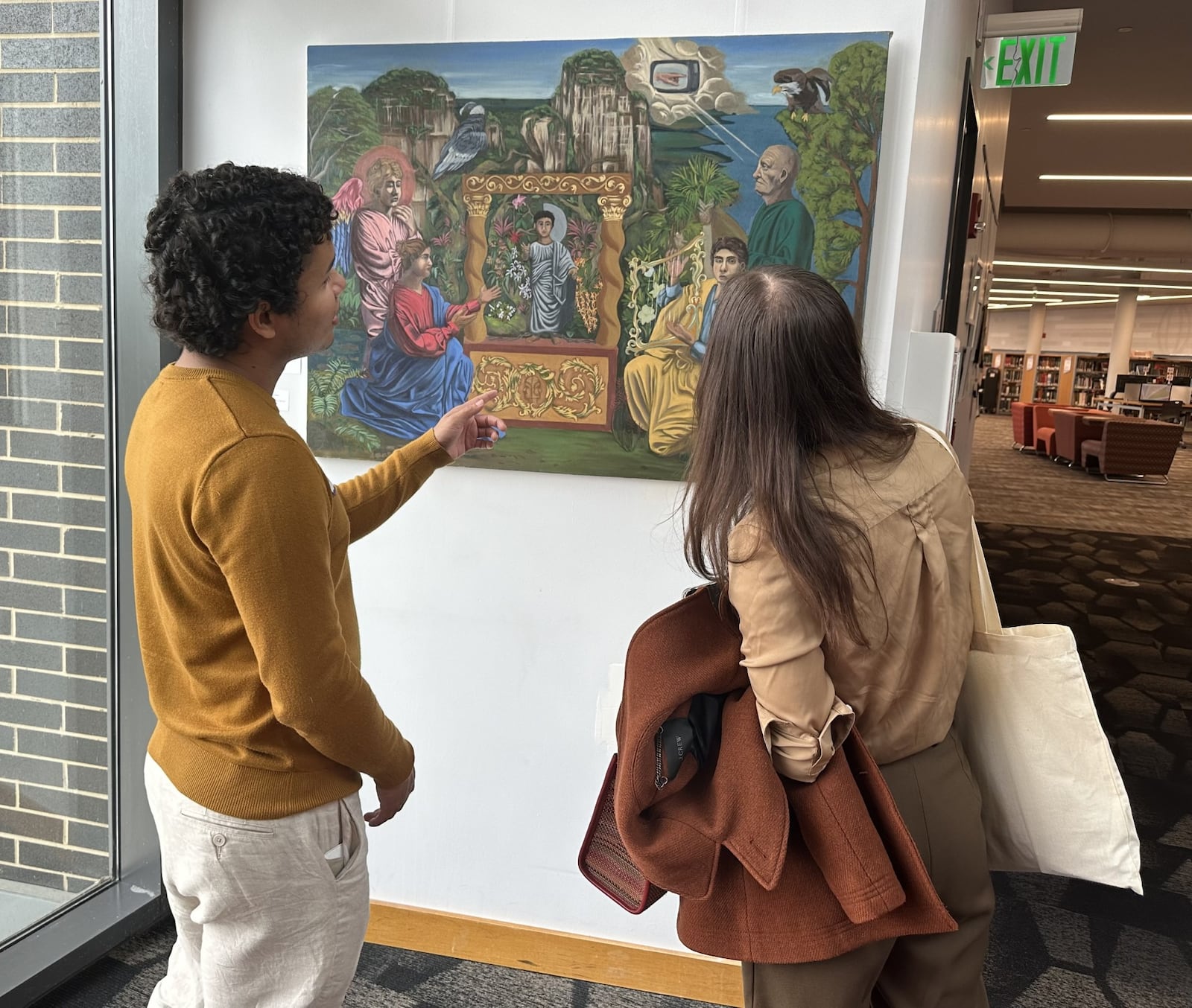 German Sanchez, from Colombia, (left) has a painting called "Con Dolor Comeras de ella Todos los Dias de tu Vida" exhibiting at the downtown Dayton Metro Library. CONTRIBUTED