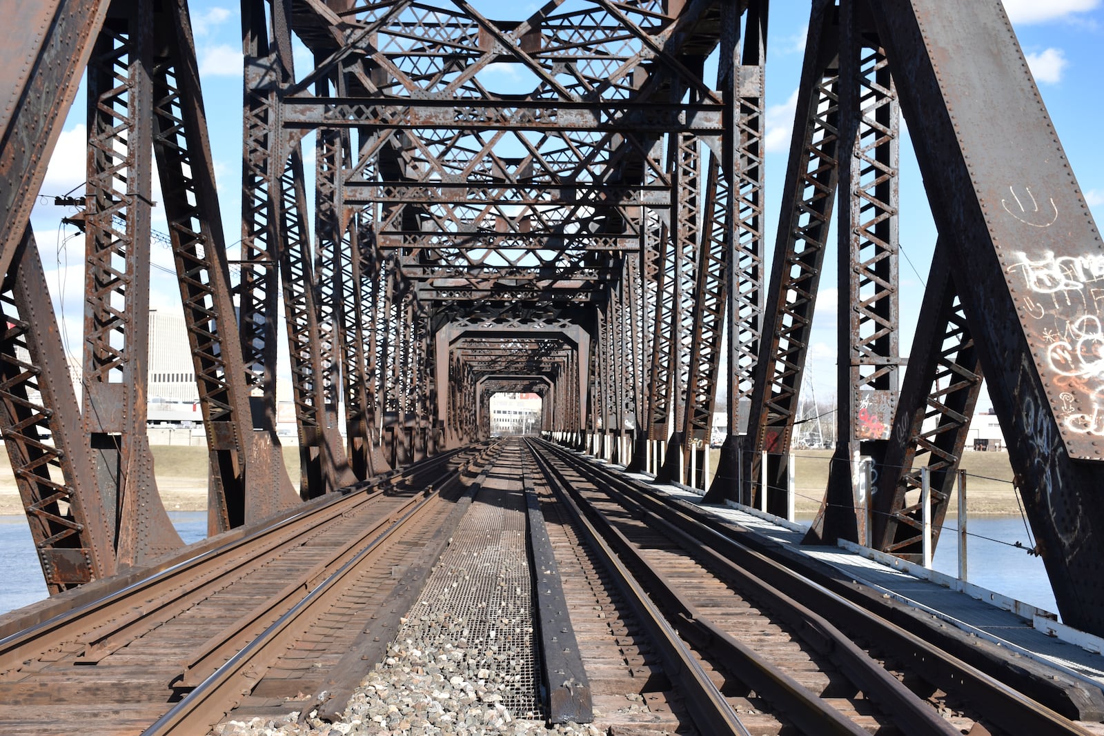 A freight train rail bridge over the Great Miami River that feeds into downtown Dayton. CORNELIUS FROLIK / STAFF