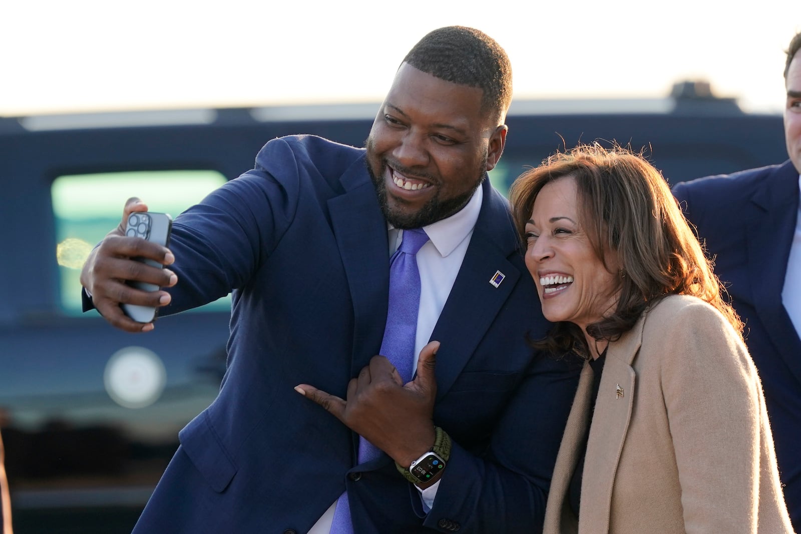 Durham, N.C. Mayor Leonardo Williams, left, takes a selfie with Democratic presidential nominee Vice President Kamala Harris as she arrives at Raleigh-Durham International Airport in Morrisville, N.C., Saturday, Oct. 12, 2024. (AP Photo/Steve Helber)