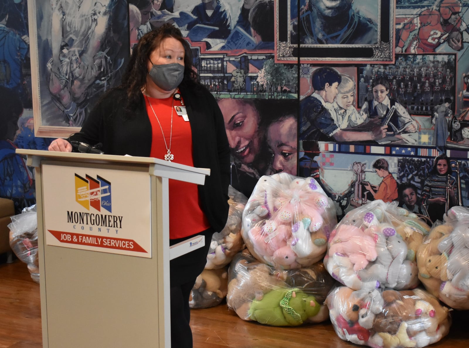 Intake Manager for Montgomery County Children Services, Jennie Cole stands in front of 300 teddy bears donated to the Haines Children's Center by the National Council of Negro Women, Dayton section, Friday Feb. 12, 2021. Contributed photo