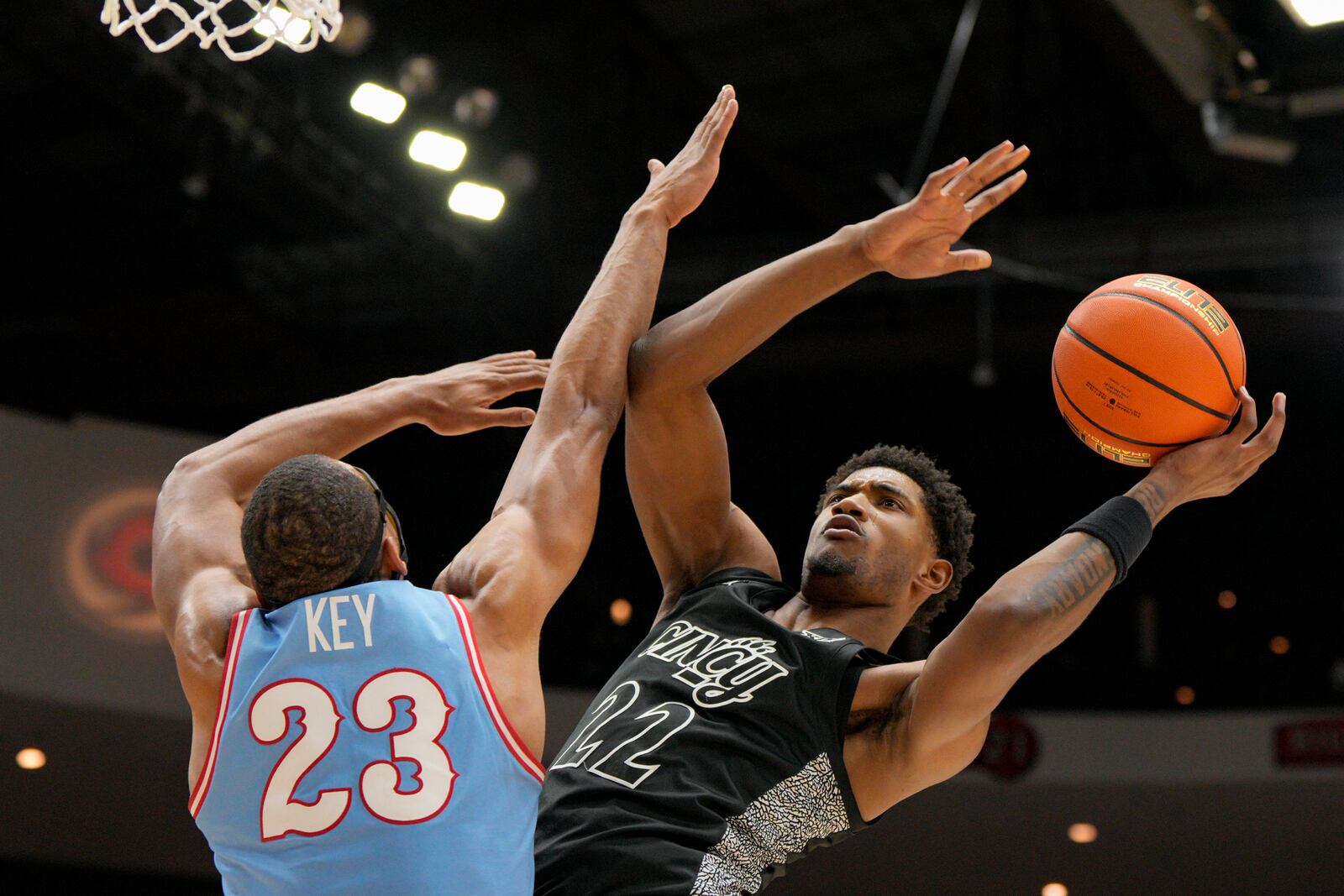 Cincinnati forward Arrinten Page (22) shoots against Dayton forward Zed Key (23) during the first half of an NCAA college basketball game, Friday, Dec. 20, 2024, in Cincinnati. (AP Photo/Jeff Dean)