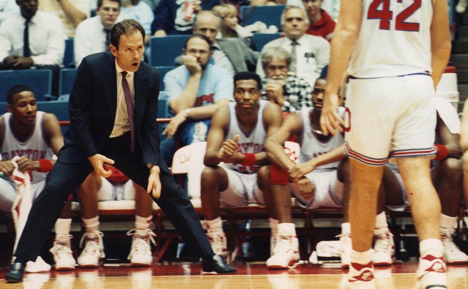 Dayton's Jim O'Brien instructs players on the floor in a game.