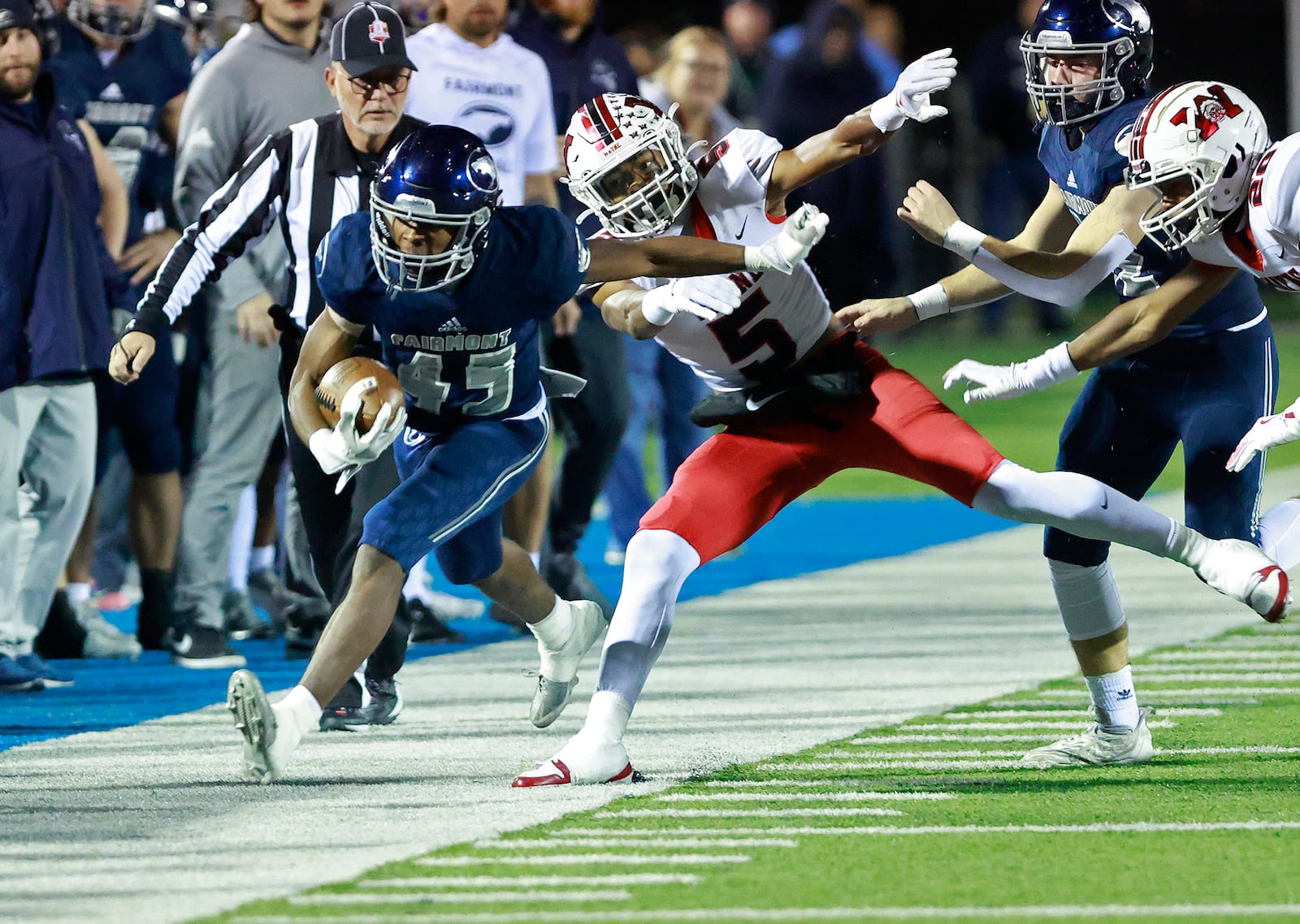 Fairmont's Kameron Thornton is shoved out of bounds by Wayne's Jussiah Williams-West during round two of the playoffs Friday, Nov. 8, 2024. BILL LACKEY/STAFF