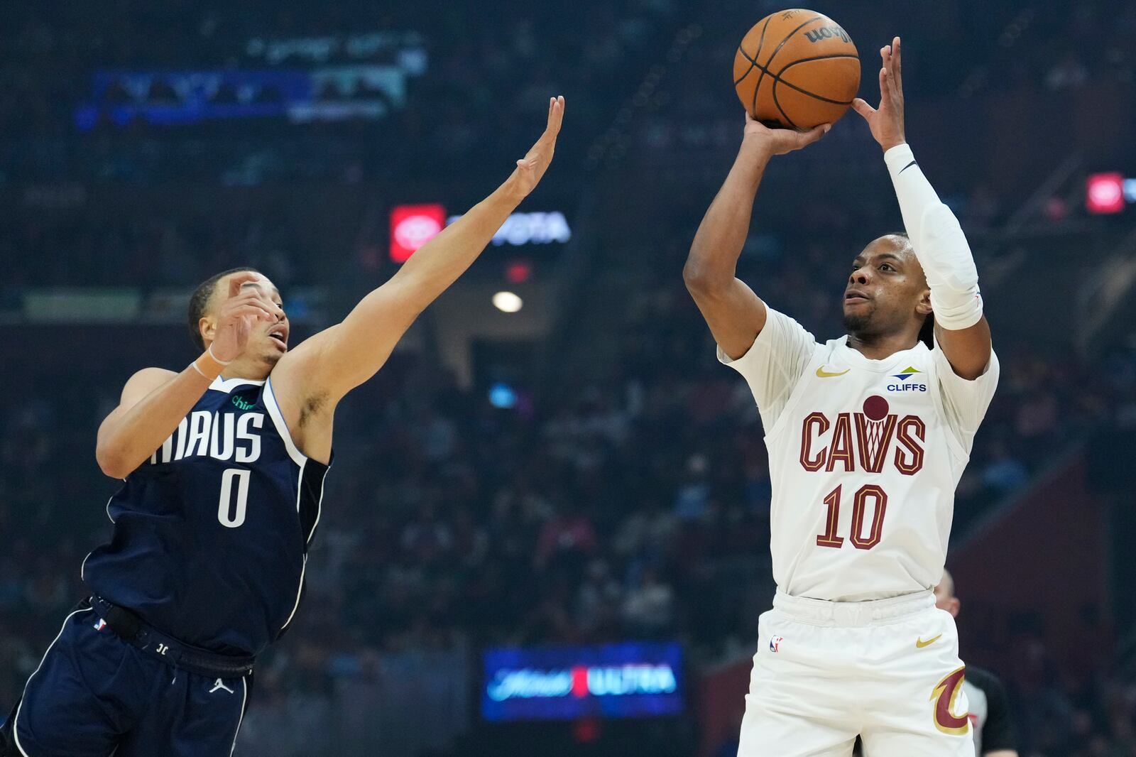 Cleveland Cavaliers guard Darius Garland (10) prepares to shoot a 3-point basket while defended by Dallas Mavericks guard Dante Exum (0) in the first half of an NBA basketball game, Sunday, Feb. 2, 2025, in Cleveland. (AP Photo/Sue Ogrocki)