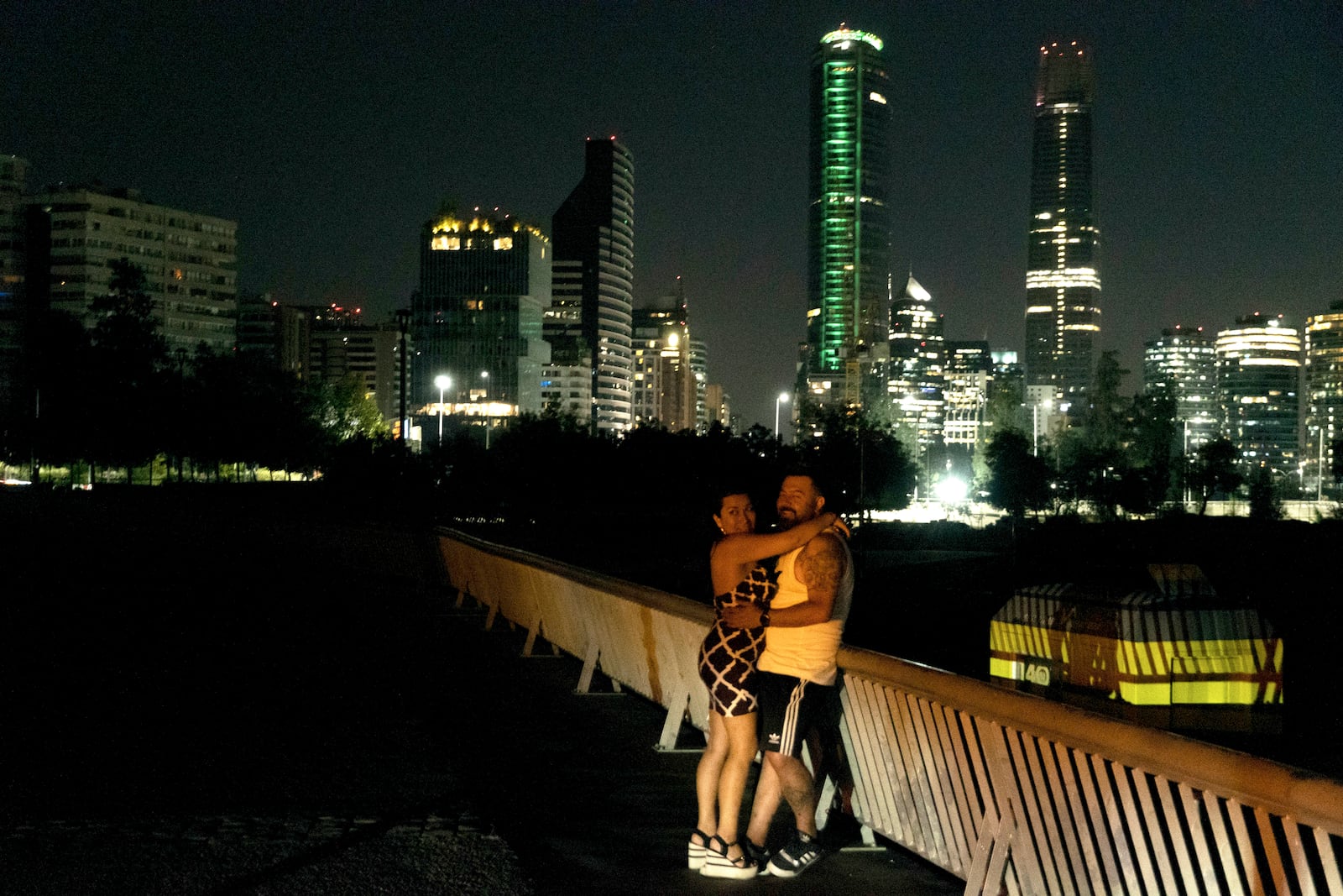 A couple embraces on a street during a power outage in Santiago, Chile, Tuesday, Feb. 25, 2025. (AP Photo/Matias Basualdo)