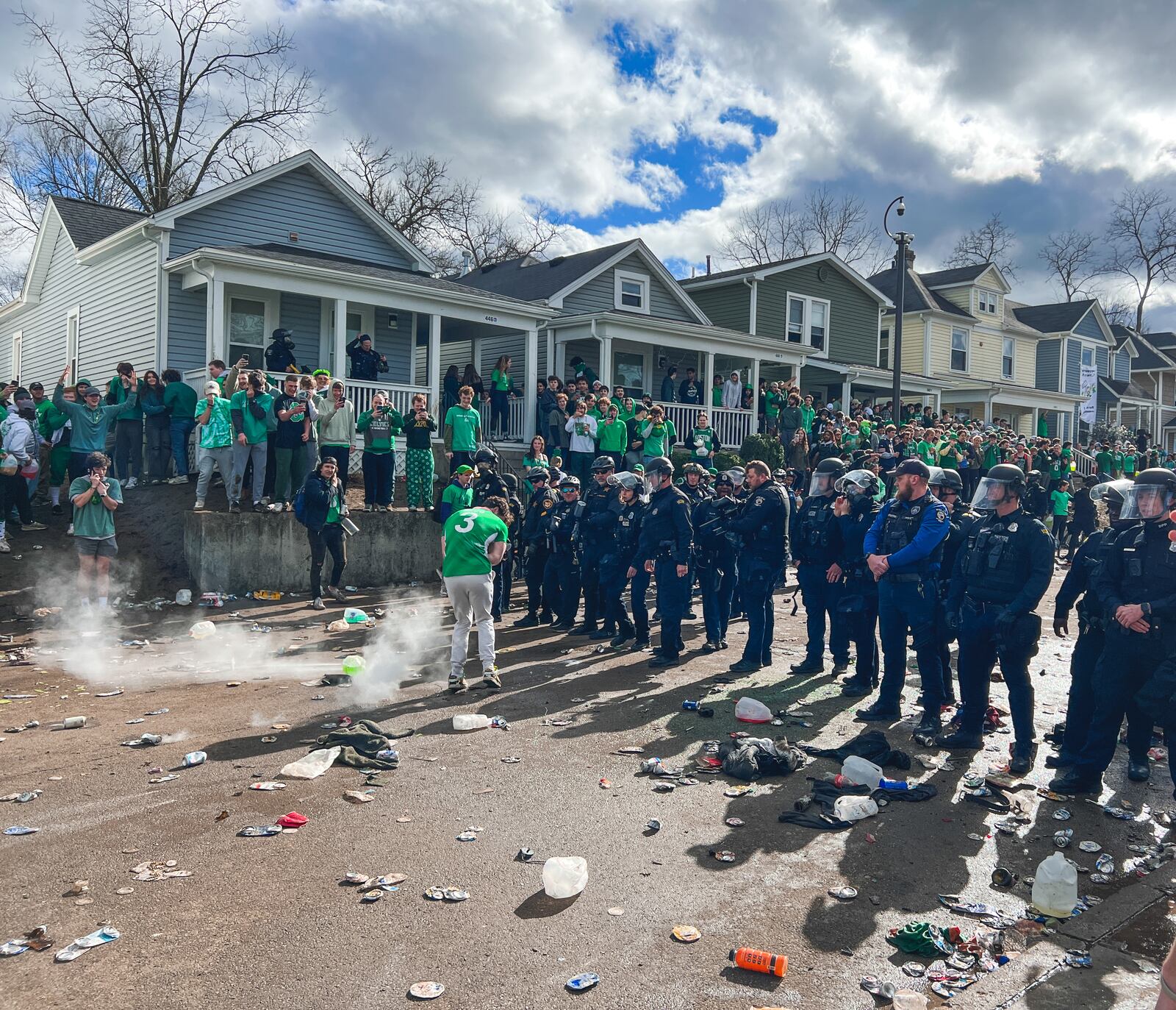 Police officers stand in formation in an attempt to quell a disturbance on Saturday, March 25, 2023, in the University of Dayton campus area. Some people overturned a vehicle, and at least six people were arrested, according to university officials. KEEGAN GUPTA/CONTRIBUTED