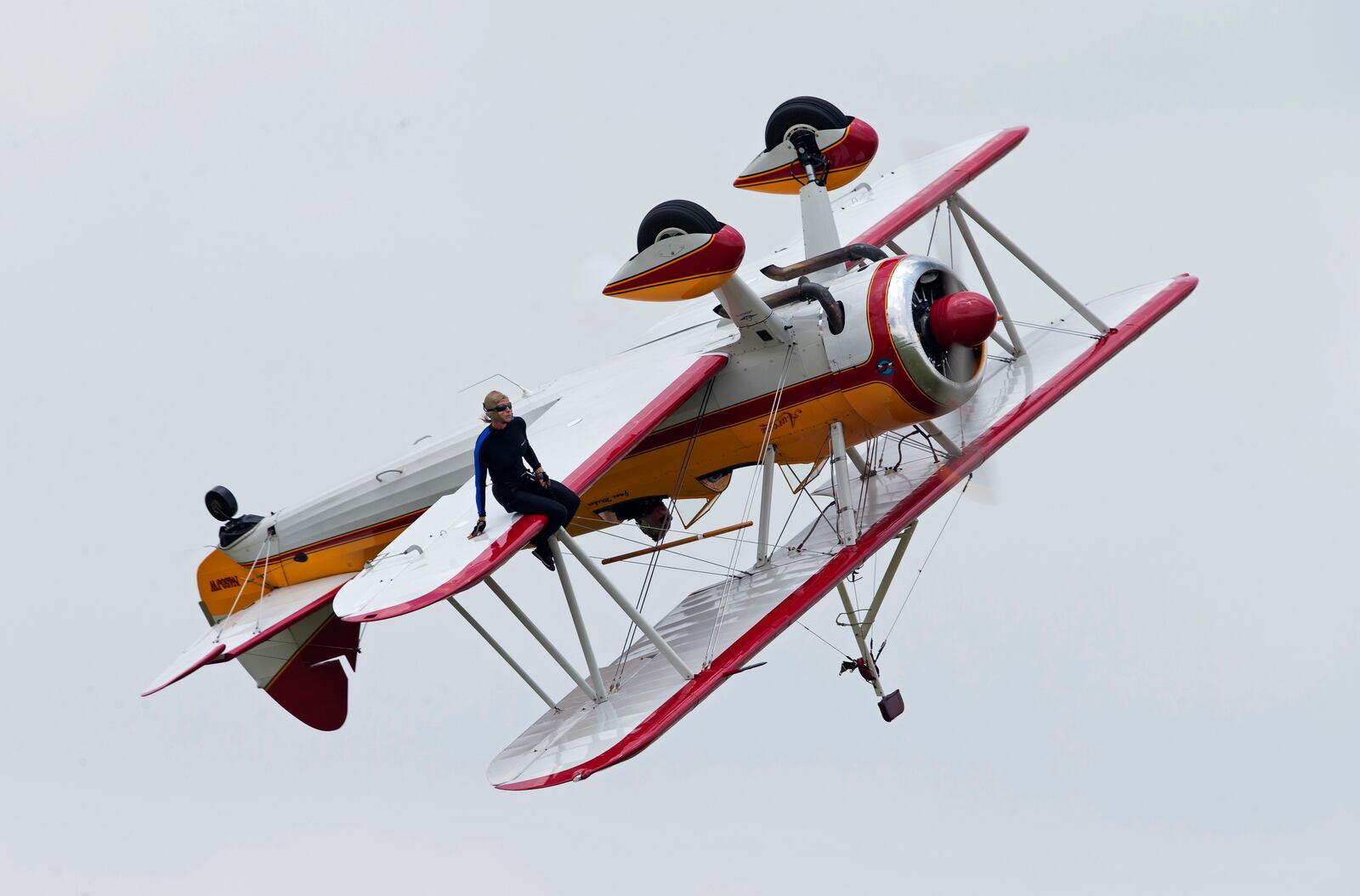 A wing walker performs at the Vectren Air Show just before crashing, Saturday, June 22, 2013, in Dayton, Ohio. The crash killed the pilot and the stunt walker instantly, authorities said. (AP Photo/Thanh V Tran)