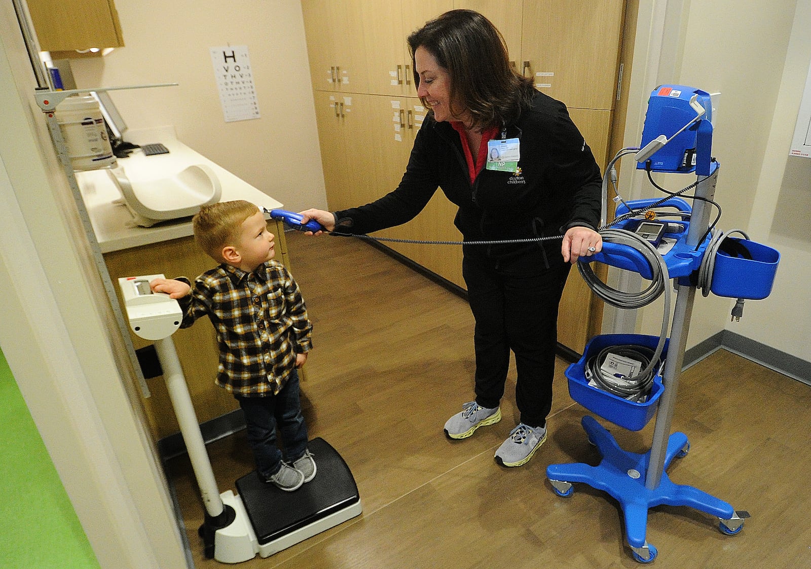 Shellee Halton, RN, takes the temperature of Caleb Sorrell, age 3,  Monday, Nov. 27, 2023 at the new Kids Express located at 6044 Wilmington Pike in Sugarcreek Plaza. MARSHALL GORBY\STAFF