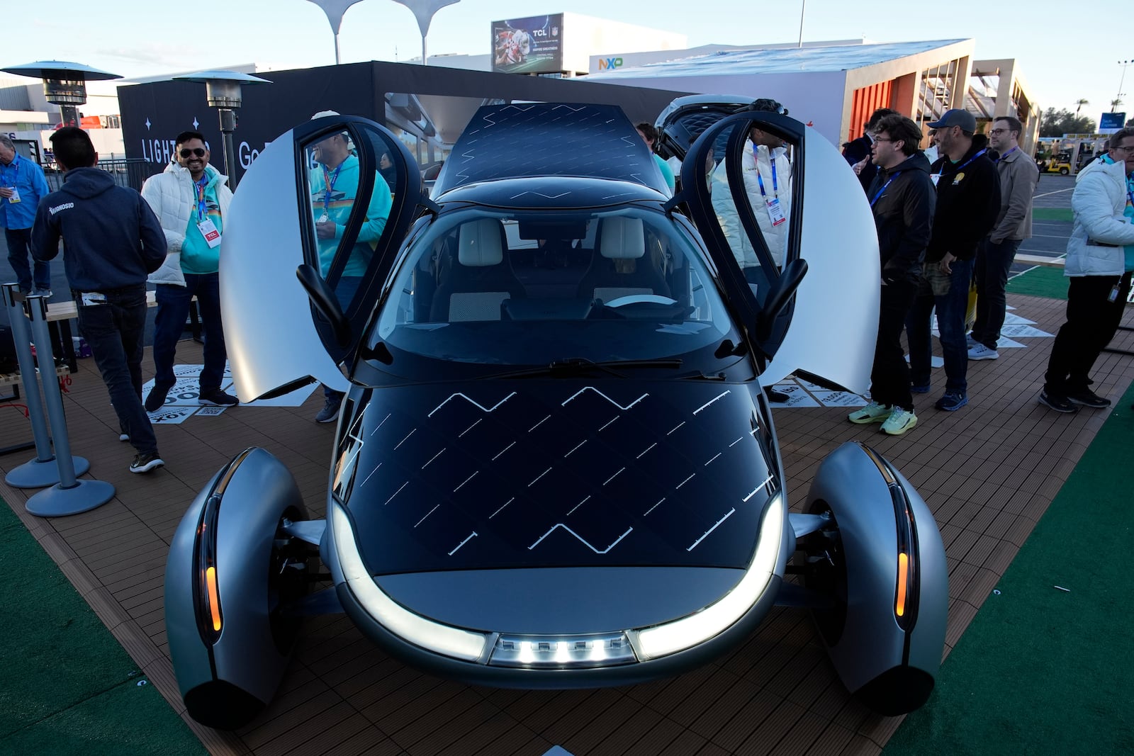 People look at a prototype solar electric vehicle by Aptera Motors during the CES tech show Tuesday, Jan. 7, 2025, in Las Vegas. (AP Photo/John Locher)