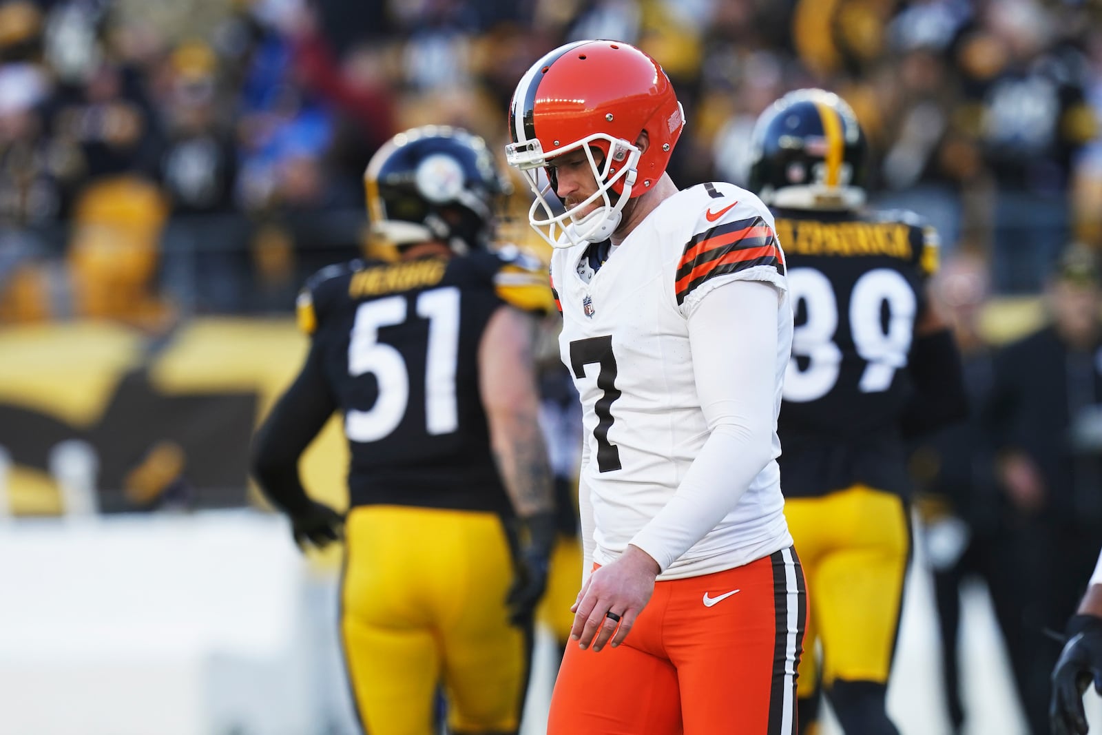 Cleveland Browns place kicker Dustin Hopkins (7) walks off the field after missing a field goal in the second half of an NFL football game against the Pittsburgh Steelers in Pittsburgh, Sunday, Dec. 8, 2024. (AP Photo/Matt Freed)