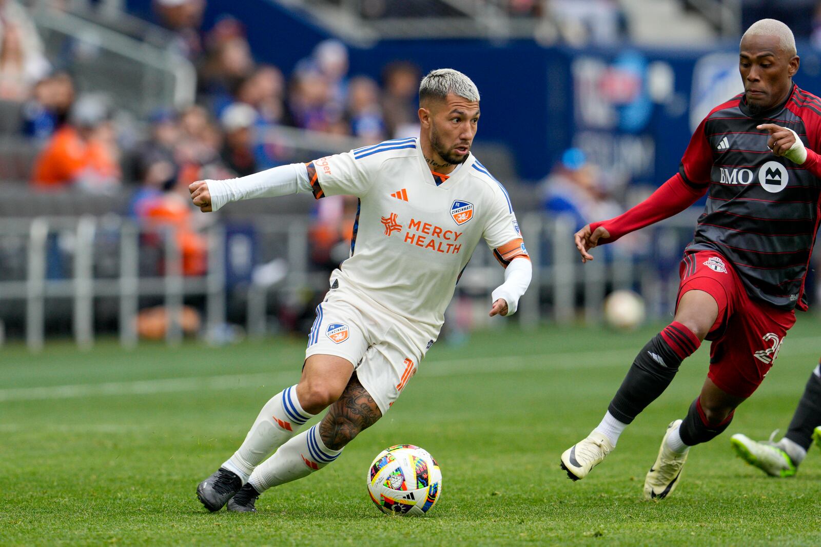 FILE - FC Cincinnati midfielder Luciano Acosta (10) controls the ball against Toronto FC midfielder Deybi Flores (20) during an MLS soccer match, Feb. 25, 2024, in Cincinnati. (AP Photo/Jeff Dean, File)