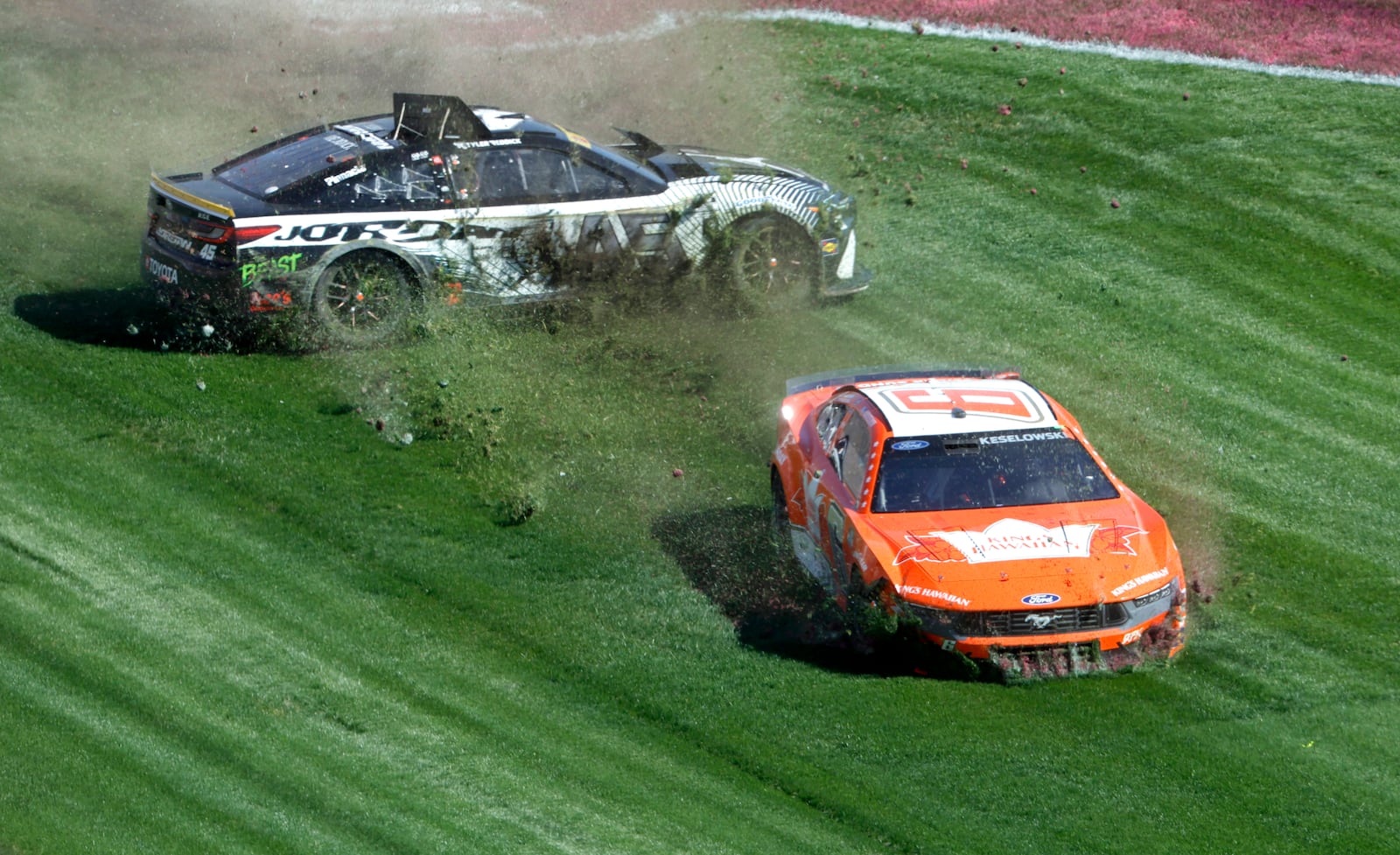 NASCAR Cup Series drivers Tyler Reddick (45) and Brad Keselowski (6) slide through the infield grass after a crash during a NASCAR Cup Series auto race at the Las Vegas Motor Speedway Sunday, Oct. 20, 2024, in Las Vegas. (Steve Marcus/Las Vegas Sun via AP)