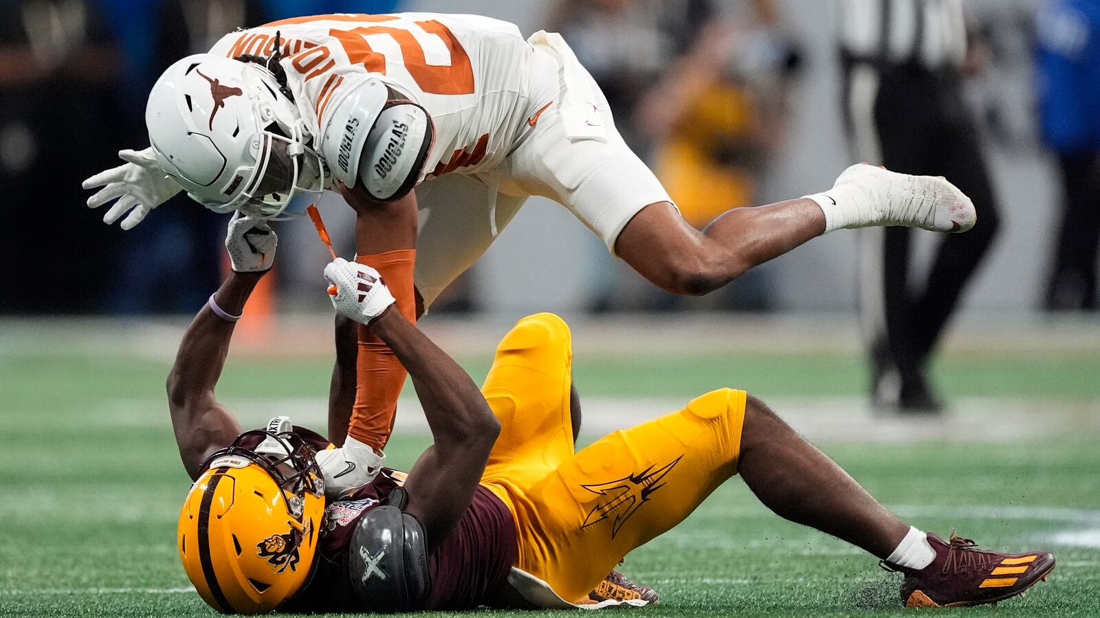 Arizona State wide receiver Melquan Stovall (5) and Texas defensive back Warren Roberson (24) collide during the first half in the quarterfinals of a College Football Playoff, Wednesday, Jan. 1, 2025, in Atlanta. (AP Photo/John Bazemore)