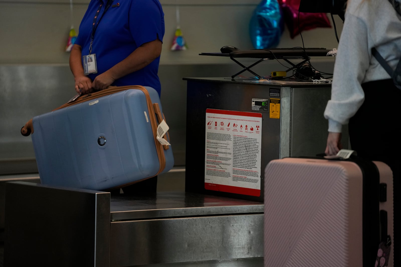 A Southwest Airlines traveler checks a bag at Midway International Airport, Tuesday, March 11, 2025, in Chicago. (AP Photo/Erin Hooley)