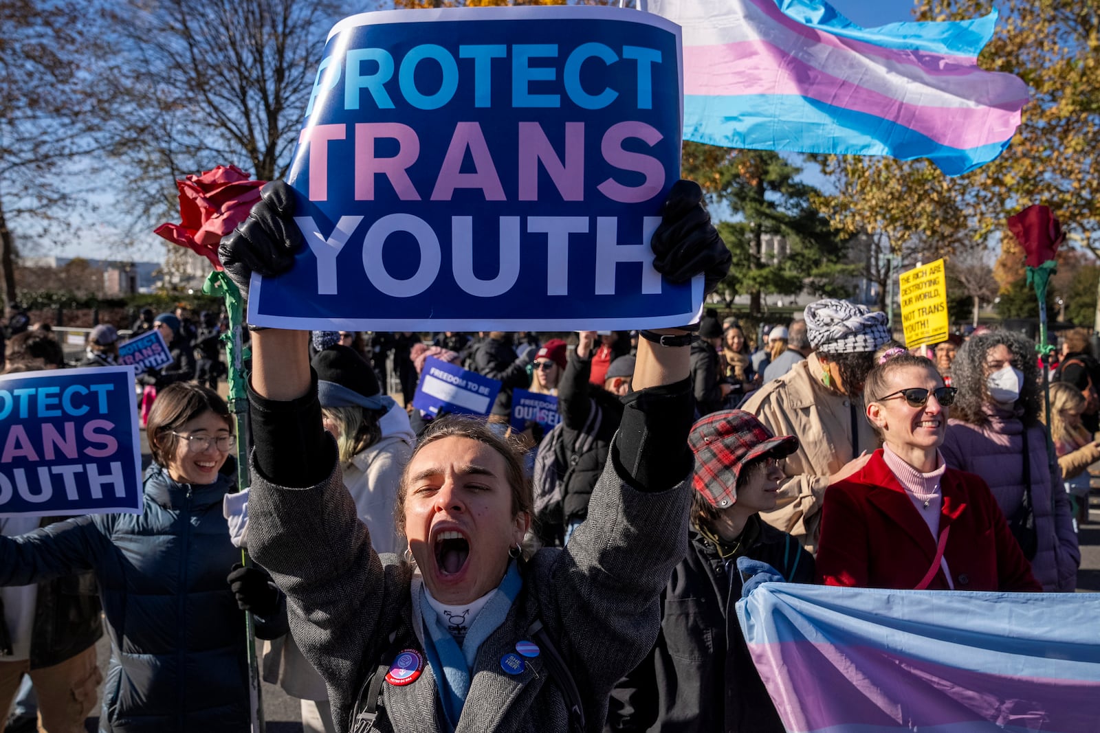 A young person who preferred not to give her name, cheers as supporters of transgender rights rally by the Supreme Court, Wednesday, Dec. 4, 2024, in Washington, as arguments begin in a case regarding a Tennessee law banning gender-affirming medical care for transgender youth. (AP Photo/Jacquelyn Martin)