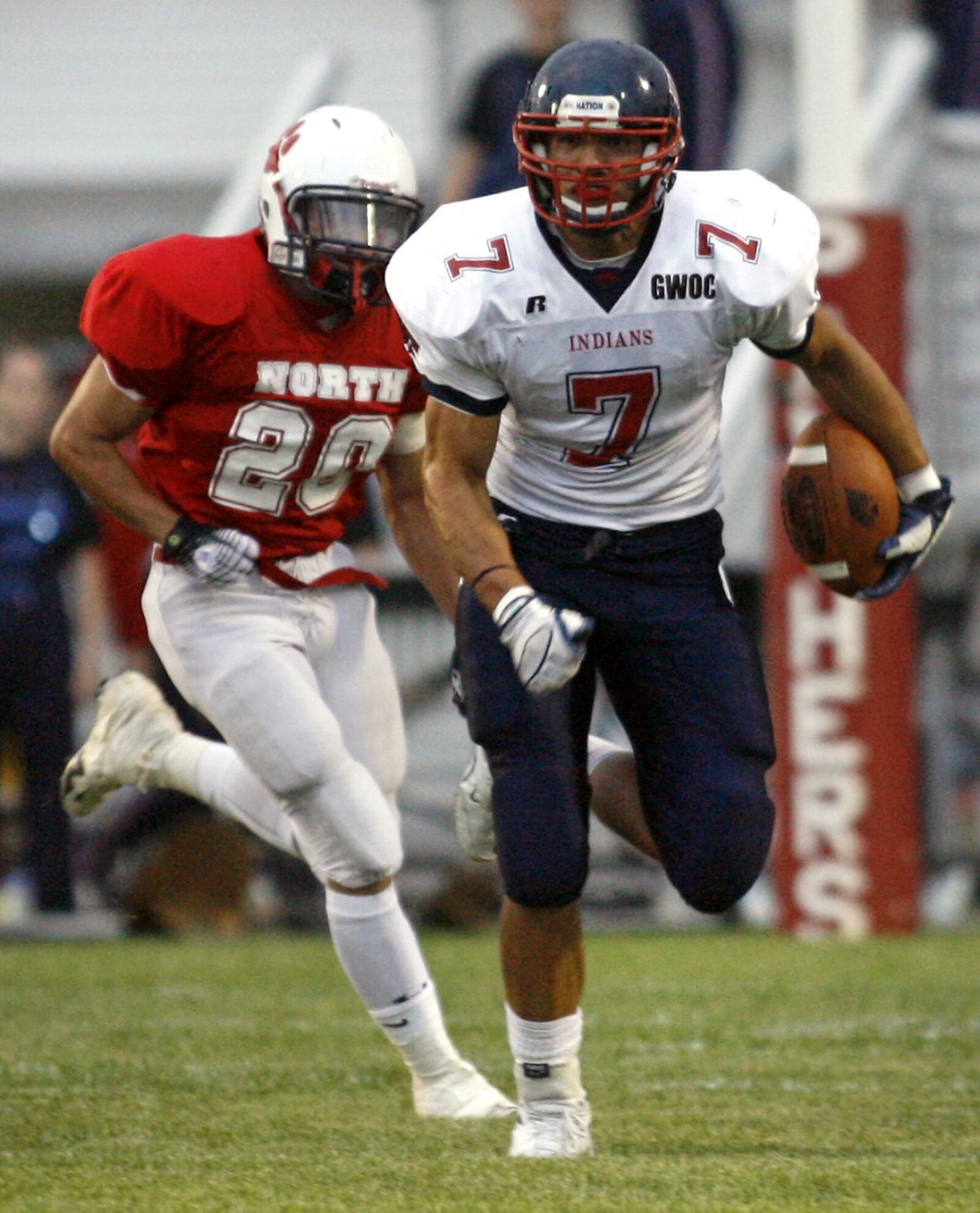 David Rolf (7) of Piqua High School is pursued by John Robinson (20) of Springfield North High School during a at North. DDN FILE