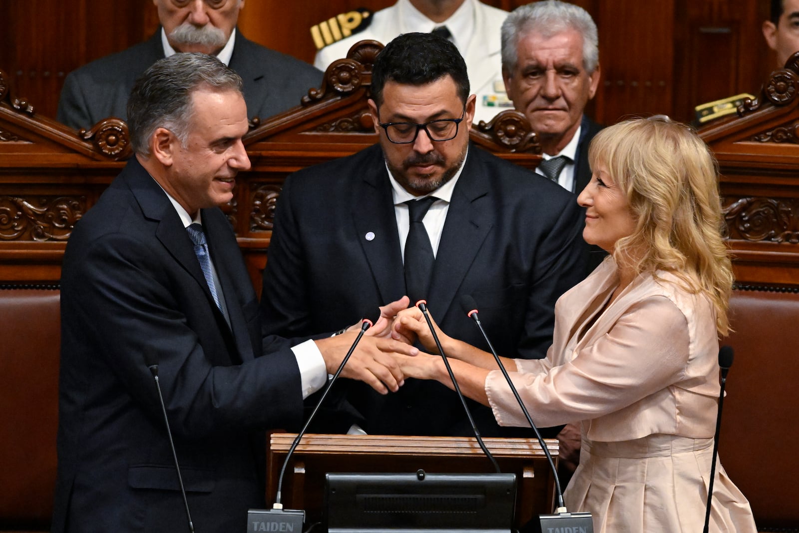 Uruguay's President-elect Yamandu Orsi holds hands with Vice President-elect Carolina Cosse in Congress during their swearing-in ceremony on Inauguration Day, in Montevideo, Uruguay, Saturday, March 1, 2025. (AP Photo/Santiago Mazzarovich)