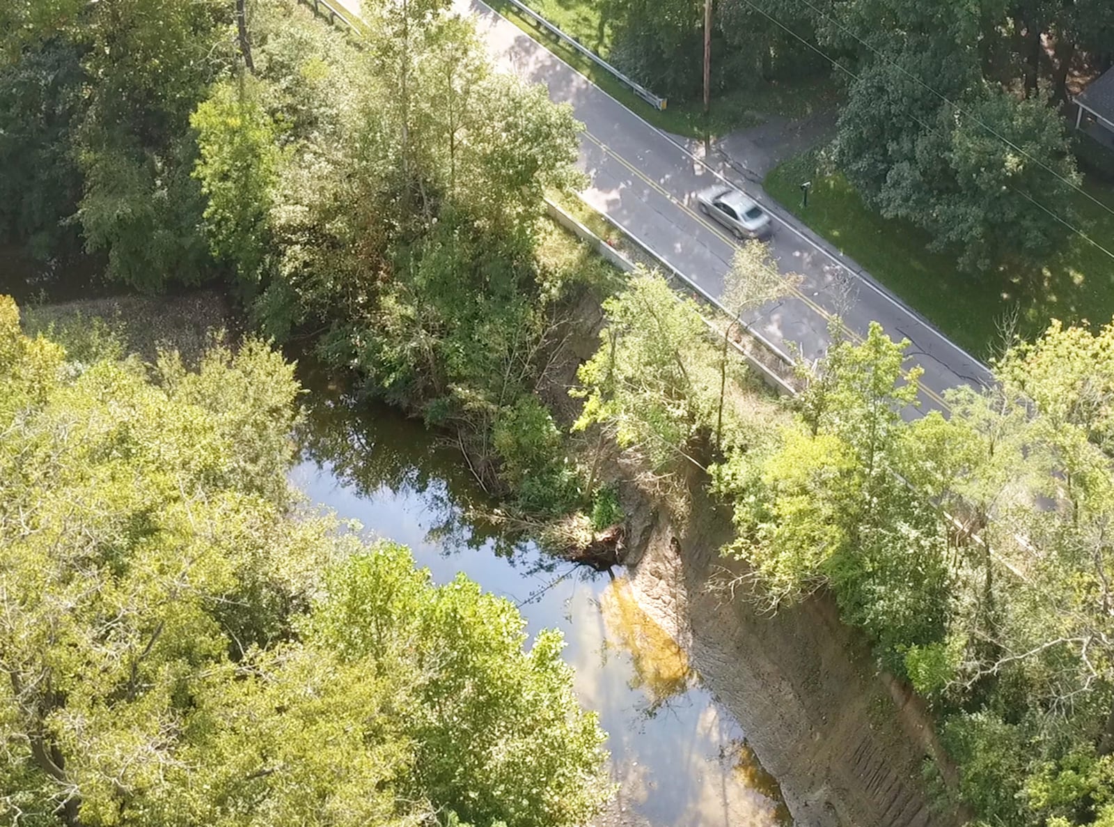 The south bank of Little Twin Creek dives nearly 30 feet down from Manning Road, which is threatened by continued erosion. Montgomery County will be spending more than $800,000 to realign and stabilize the creek. TY GREENLEES / STAFF