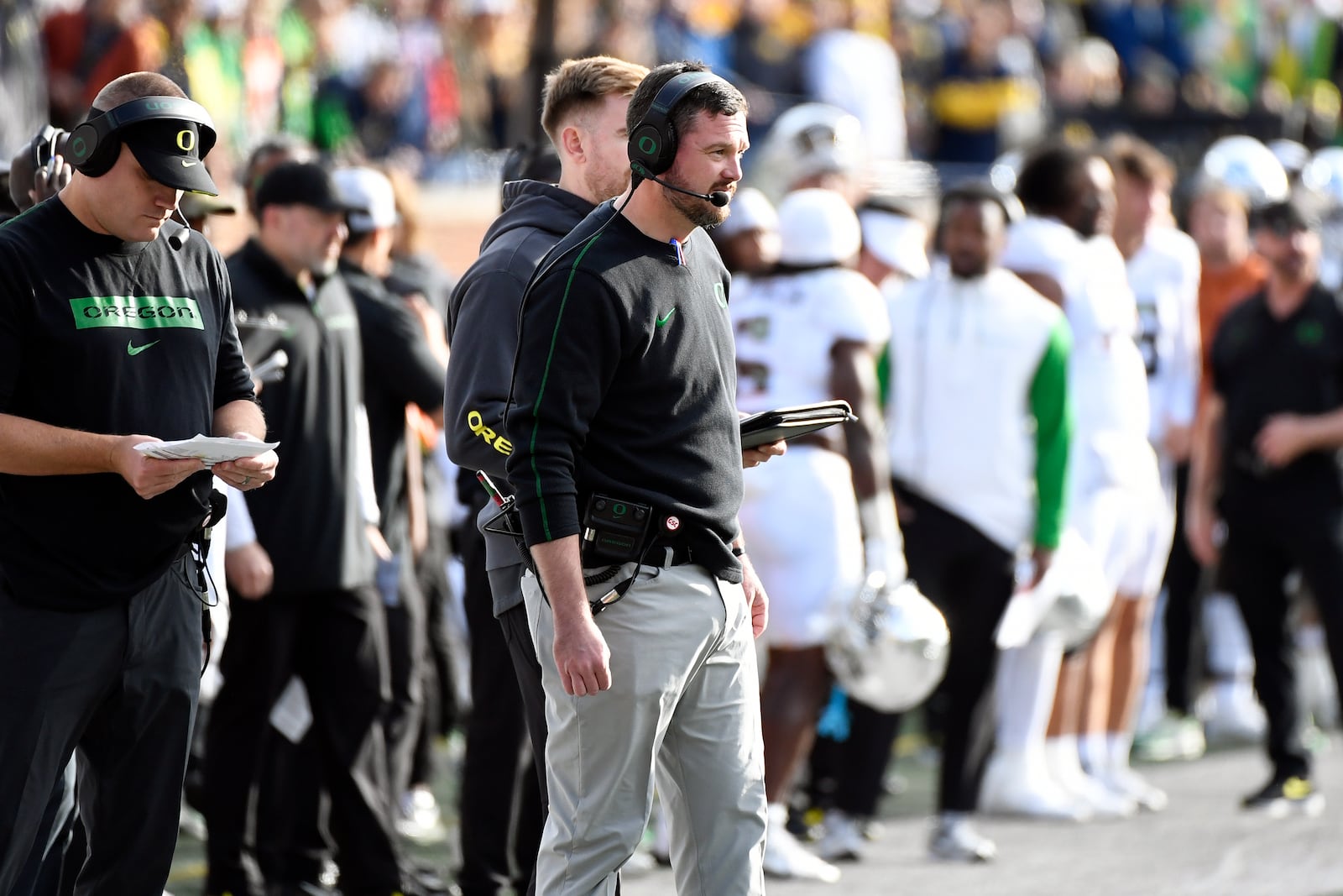 Oregon head coach Dan Lanning, front center, watches his team play against Michigan in the first half of an NCAA college football game, Saturday, Nov. 2, 2024, in Ann Arbor, Mich. (AP Photo/Jose Juarez)