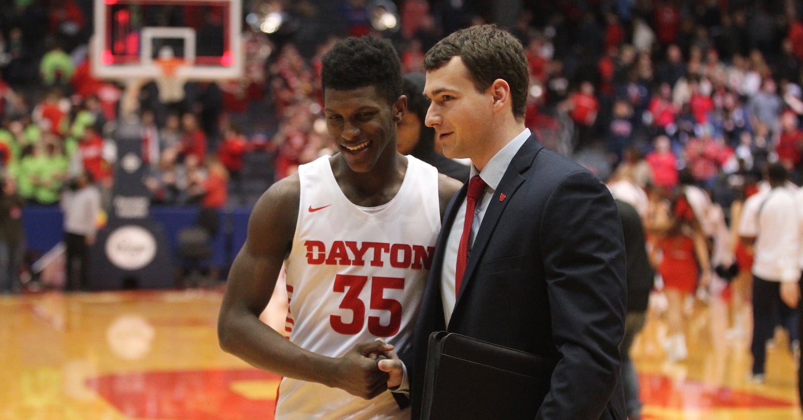 Dayton’s Dwayne Cohill, left, and graduate assistant coach Matthew Sweet leave the court after a victory against Duquesne on Saturday, Feb. 2, 2019, at UD Arena.