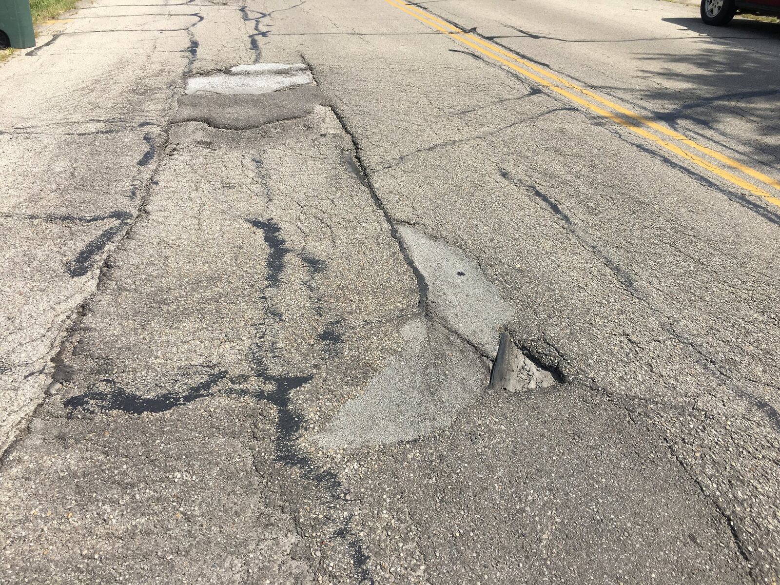 This section of Derby Road near Blairwood Ave. in Jefferson Township is in need of repair. The city is seeking a state grant for repairs to Derby Road but would have to provide a local match for the job. Lynn Hulsey/STAFF PHOTO