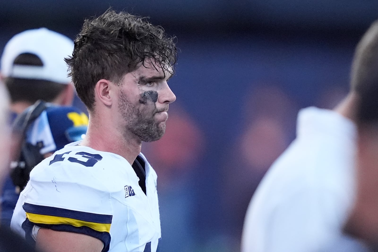 Michigan quarterback Jack Tuttle stands on the sidelines in the closing minutes of the team's 21-7 loss to Illinois in an NCAA college football game Saturday, Oct. 19, 2024, in Champaign, Ill. (AP Photo/Charles Rex Arbogast)