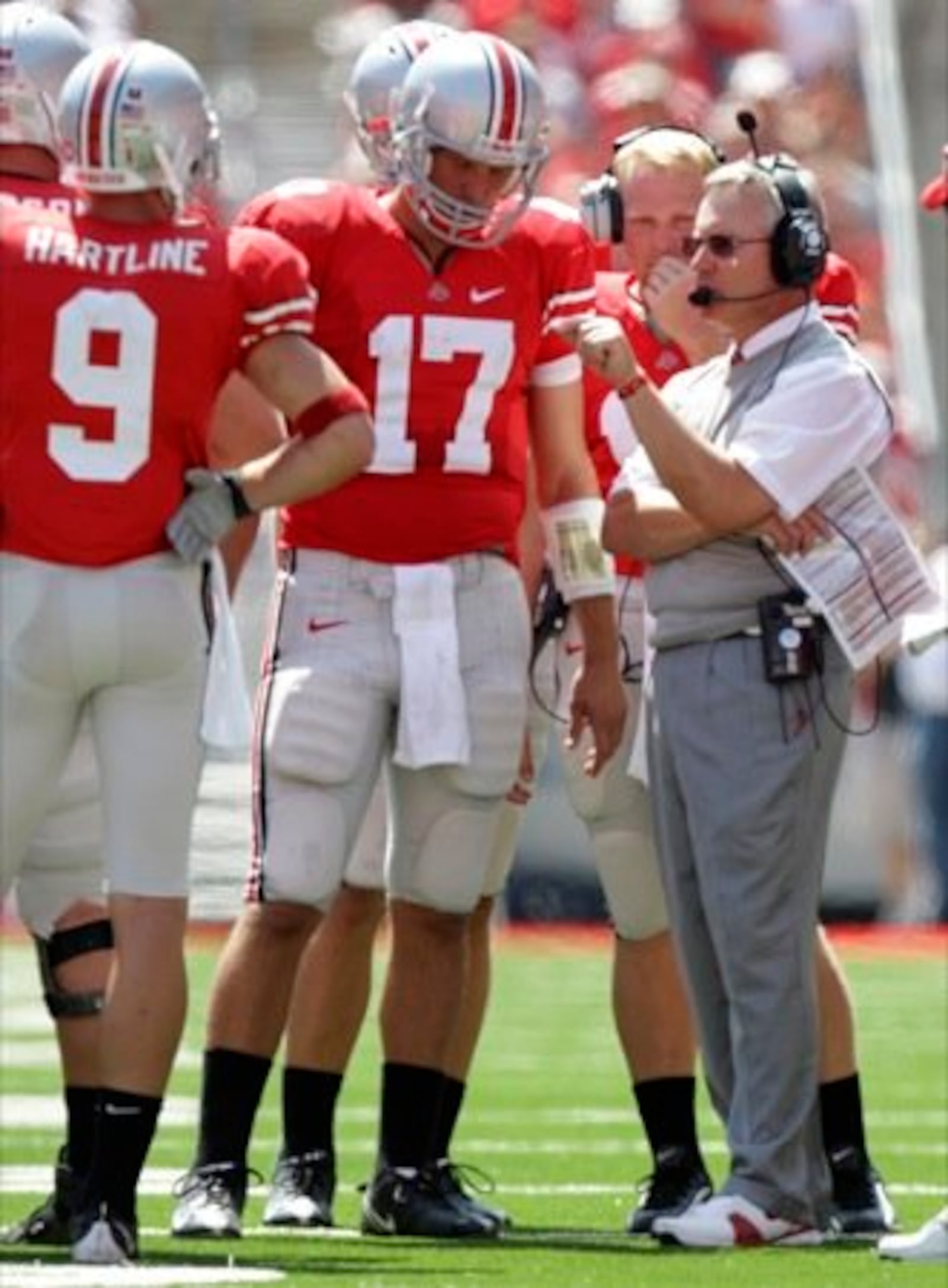 Ohio State head coach Jim Tressel, right, talks to quarterback Todd Boeckman (17) and wide receiver Brian Hartline (9) during the third quarter of a college football game Saturday, Aug. 30, 2008 in Columbus.