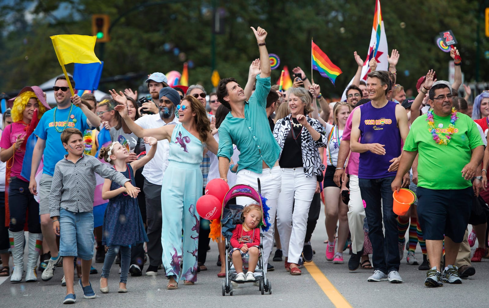 FILE - Canadian Prime Minister Justin Trudeau, center, his wife Sophie Gregoire Trudeau, center left, and their children Hadrien, in stroller, Ella-Grace, next to her mother, and Xavier, next to his sister, take part in the Pride Parade in downtown Vancouver, Canada, on July 31, 2016. (Jonathan Hayward/The Canadian Press via AP, File)