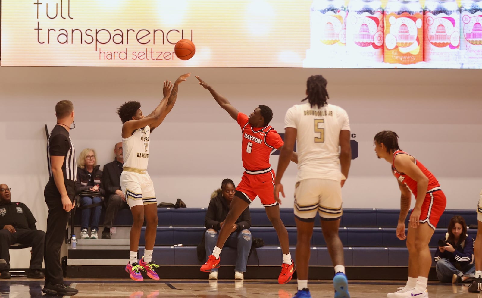 George Washington's Christian Jones makes a 3-pointer against Dayton's Enoch Cheeks on Saturday, Jan. 4, 2025, at the Charles E. Smith Center in Washington, D.C. David Jablonski/Staff