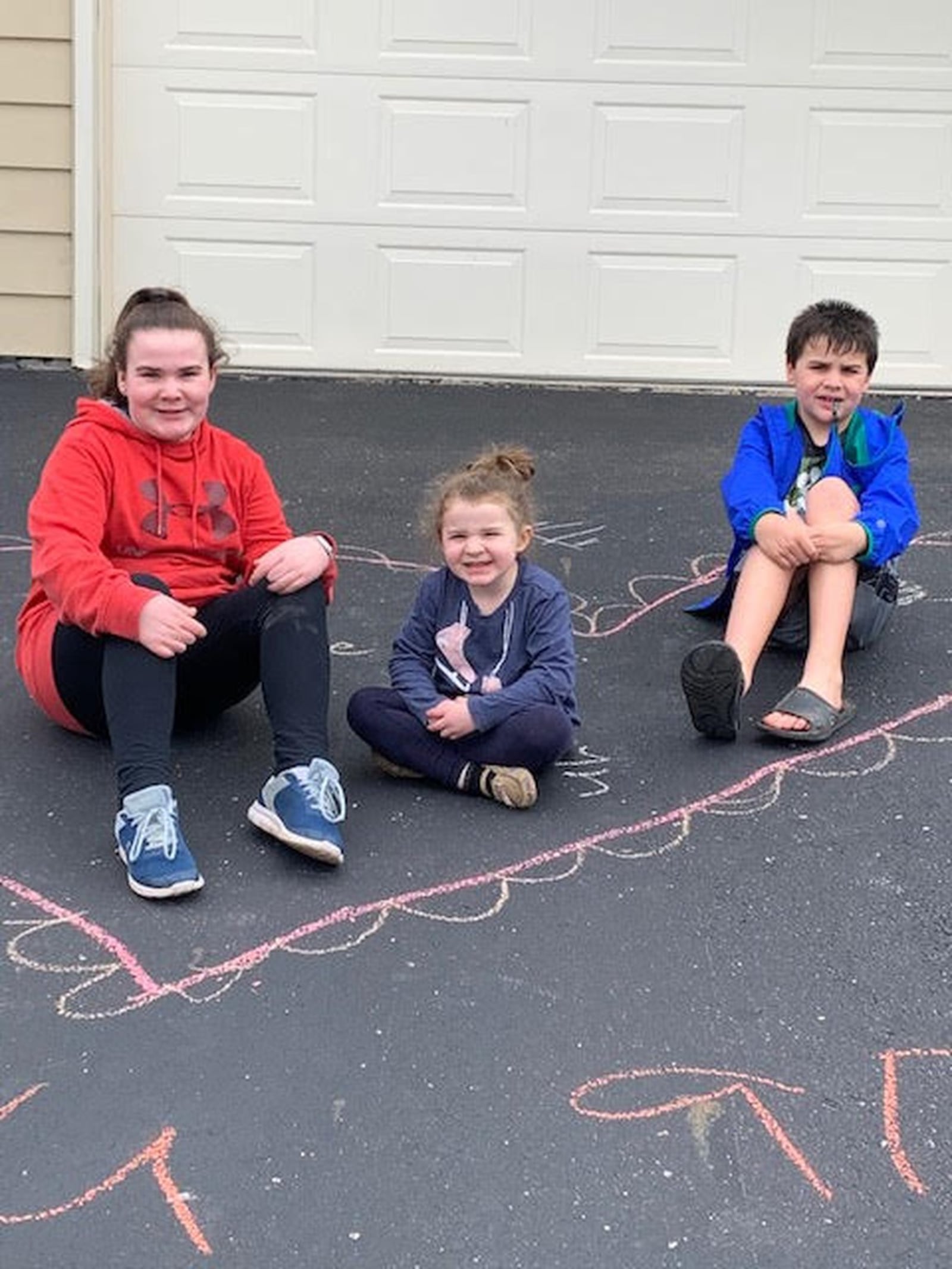 Joy Becker’s grandkids left chalk messages, cookies and cards for their relatives. The kids are Maddie, Wyatt and Carolyn Becker. CONTRIBUTED