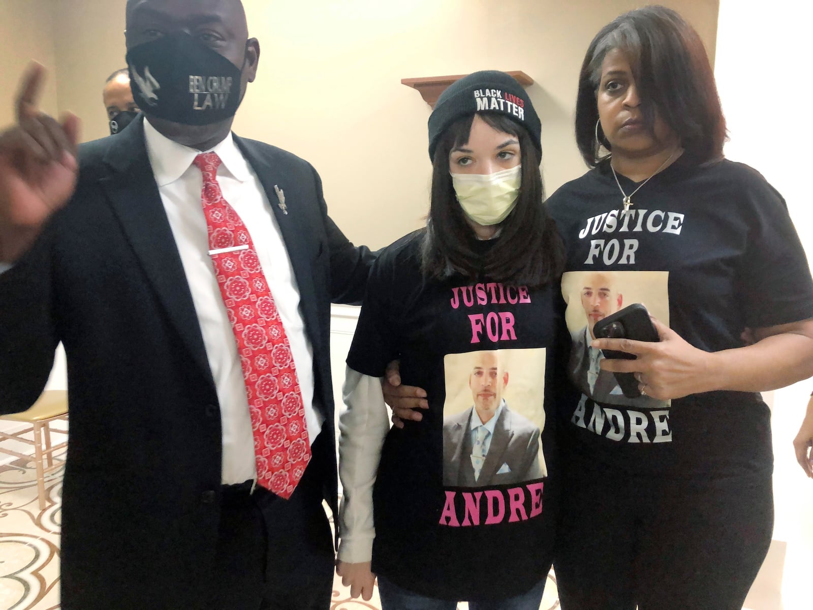 Attorney Benjamin Crump, left, discusses the police shooting of Andre Hill at a news conference attended by Hill's daughter, Karissa, center, and sister Shawna Barnett, on Thursday, Dec. 31, 2020, in Columbus, Ohio. Karissa Hill said she considered her father an "everything man" because he did so many things. (AP Photo/Andrew Welsh-Huggins)