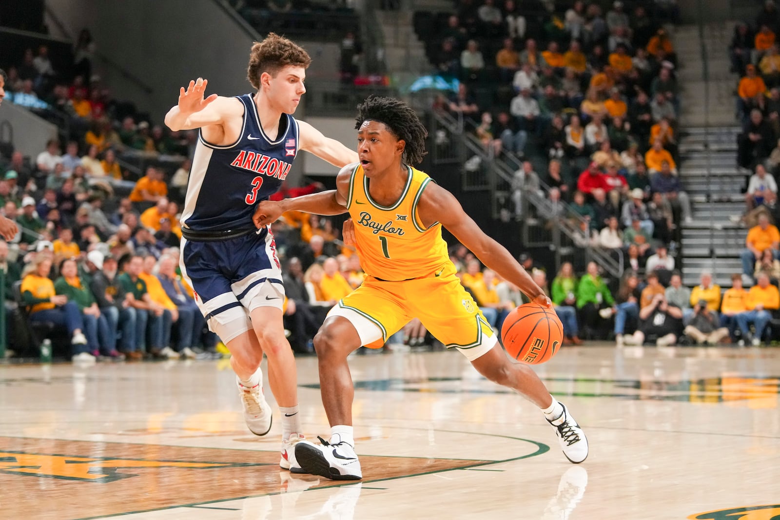 Baylor guard Robert Wright III (1) drives to the basket against Arizona guard Anthony Dell'Orso (3) during the first half of an NCAA college basketball game Monday, Feb. 17, 2025, in Waco, Texas. (AP Photo/Julio Cortez)