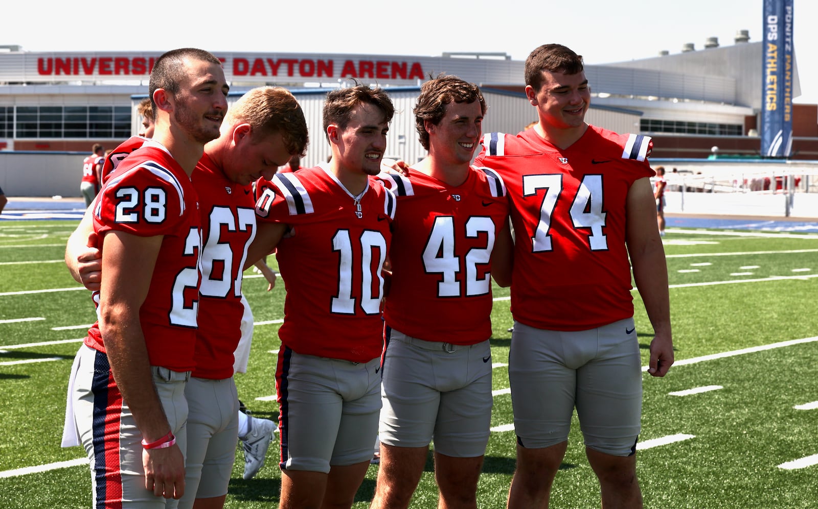 Dayton football players (left to right) Michael Franks, Sam Mueller, Luke Brenner, Michael Neel and Sam Schadek pose for a photo at Welcome Stadium on Sunday, Aug. 20, 2023. David Jablonski/Staff