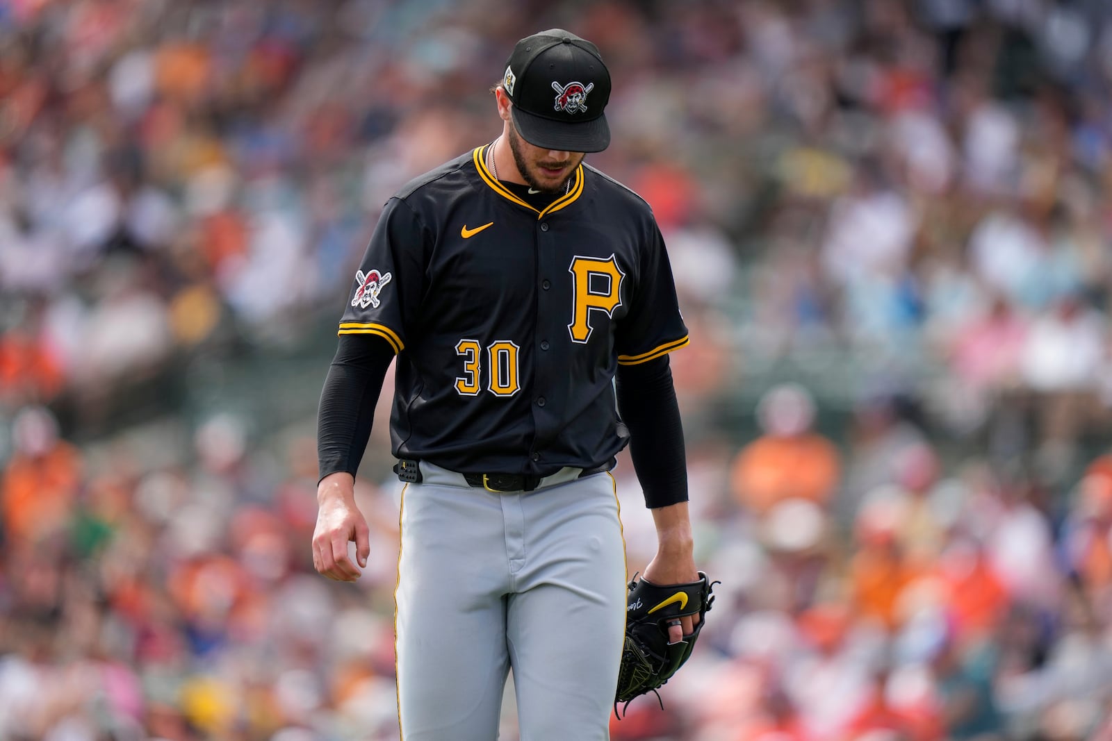 Pittsburgh Pirates starting pitcher Paul Skenes (30) returns to the dugout after the first inning of a spring training baseball game against the Baltimore Orioles, Saturday, March 1, 2025, in Sarasota, Fla. (AP Photo/Stephanie Scarbrough)