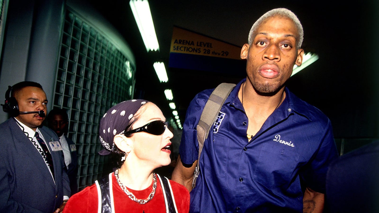 Dennis Rodman #10 of the San Antonio Spurs leaves the arena with Madonna after playing an NBA game against the Los Angeles Clippers at The Los Angeles Sports Arena on April 24, 1994 in Los Angeles.