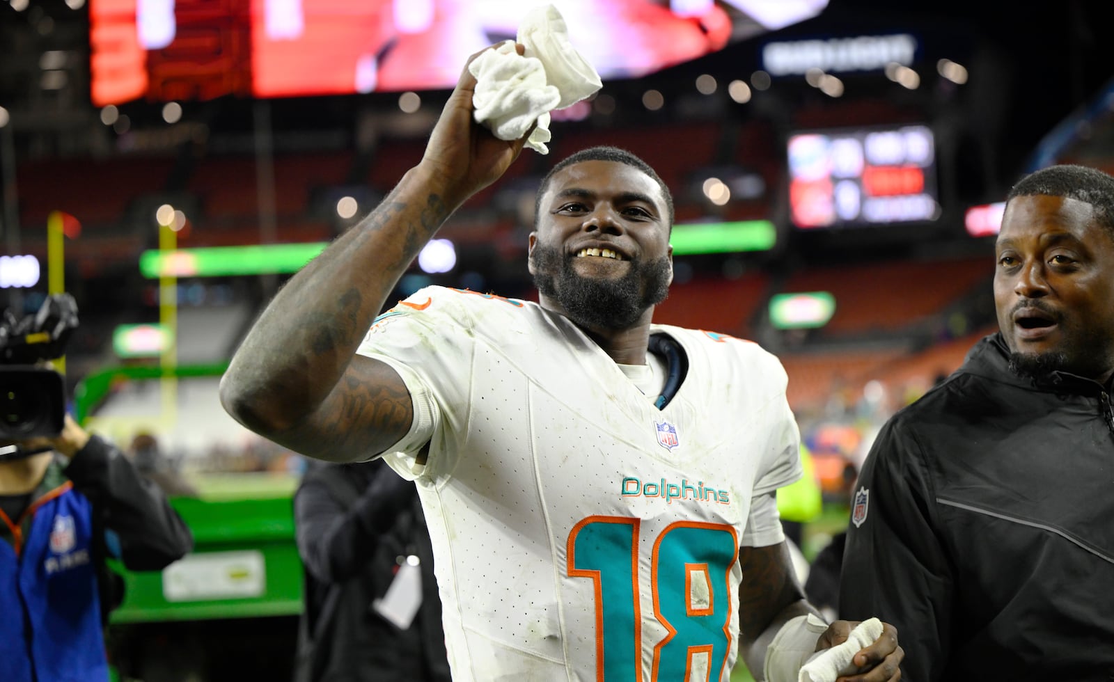 Miami Dolphins quarterback Tyler Huntley (18) runs off the field after the Dolphins defeated the Cleveland Browns in an NFL football game Sunday, Dec. 29, 2024, in Cleveland. (AP Photo/David Richard)