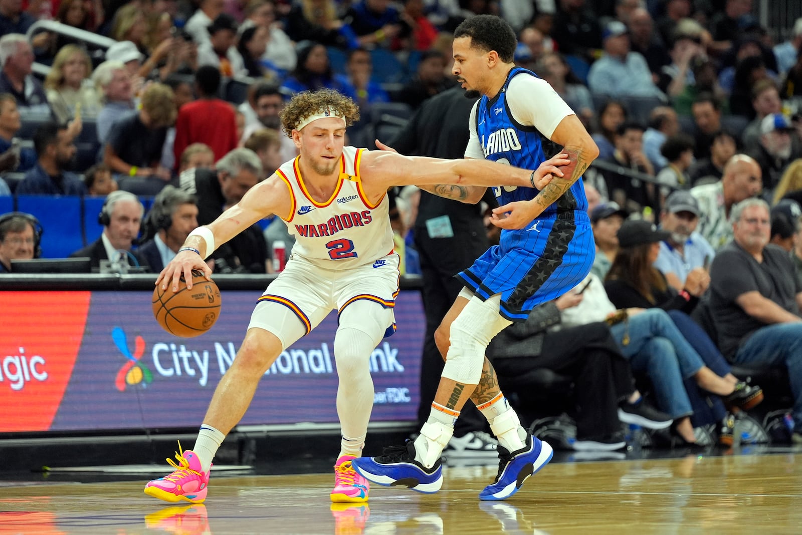 Golden State Warriors guard Brandin Podziemski (2) works to get around Orlando Magic guard Cole Anthony, right, during the first half of an NBA basketball game, Thursday, Feb. 27, 2025, in Orlando, Fla. (AP Photo/John Raoux)